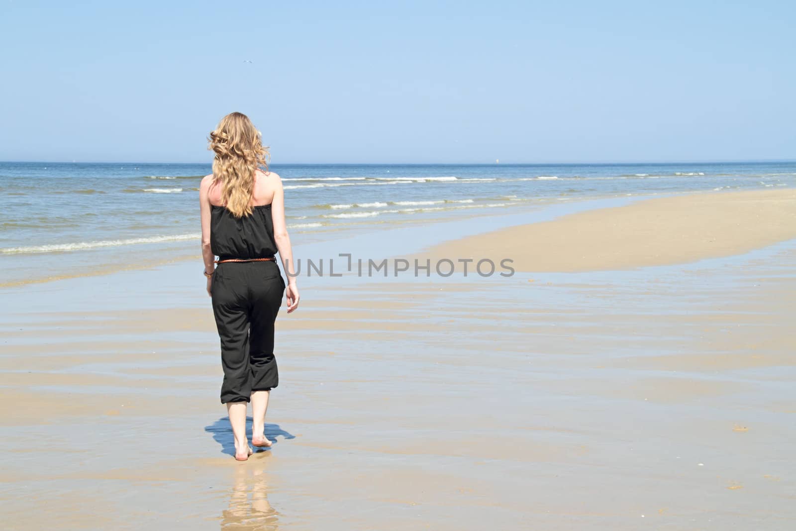 Beautiful young blonde woman at the beach by devy