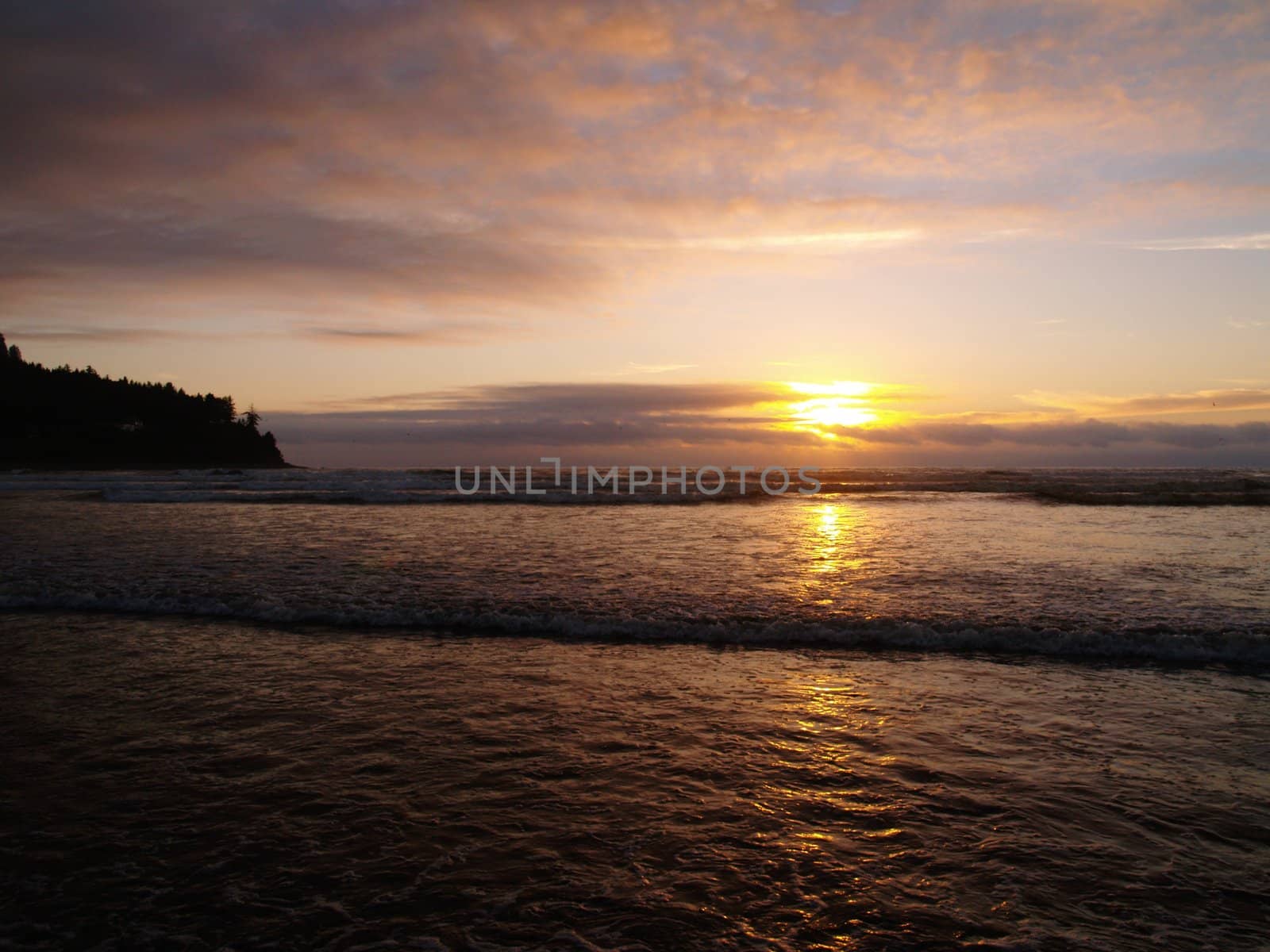 Beautiful Sunset Over the Ocean wth Waves in the Foreground