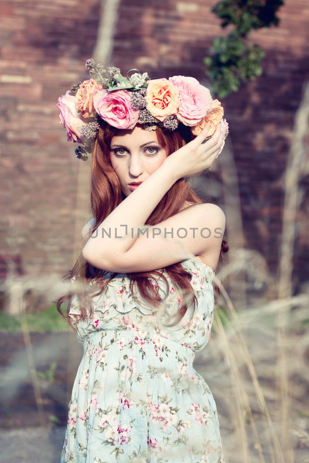 beautfiul woman outdoor in summer with flowers on head romantic fashion