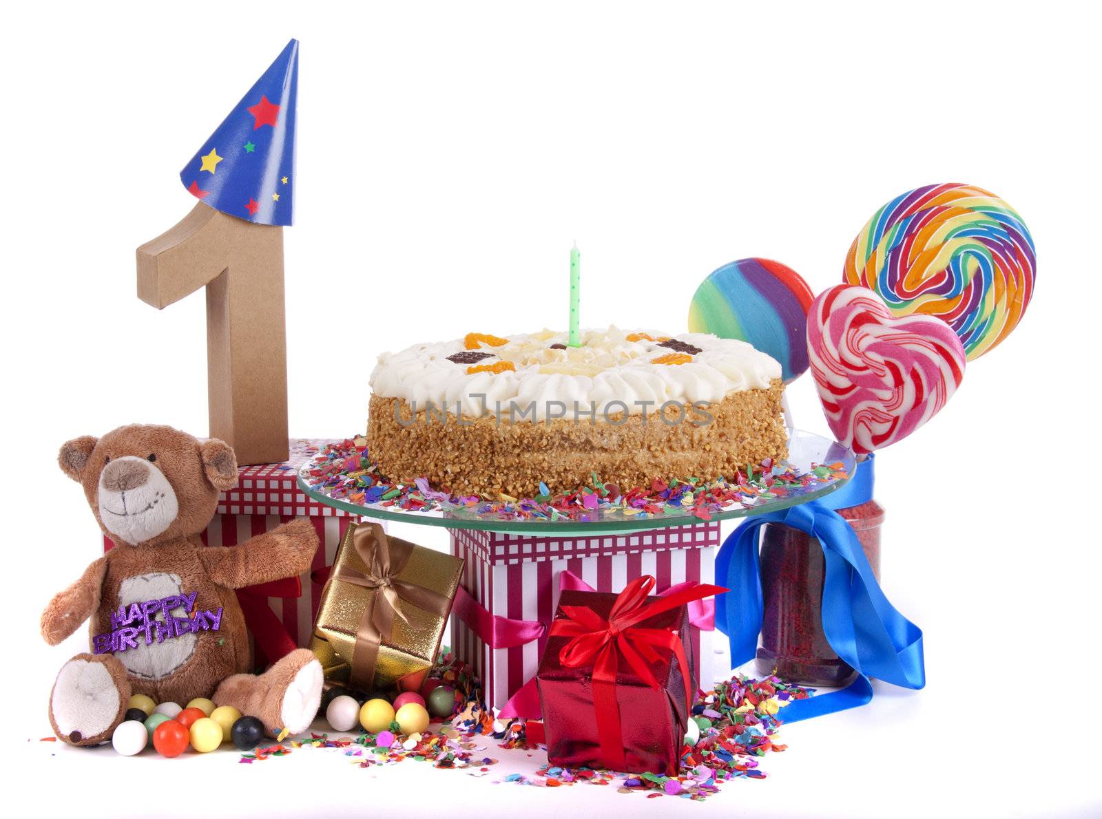 Number of age in a colorful studio setting with paper party hats, a red heart and gifts on a bottom of confetti and sweet cake with candles 