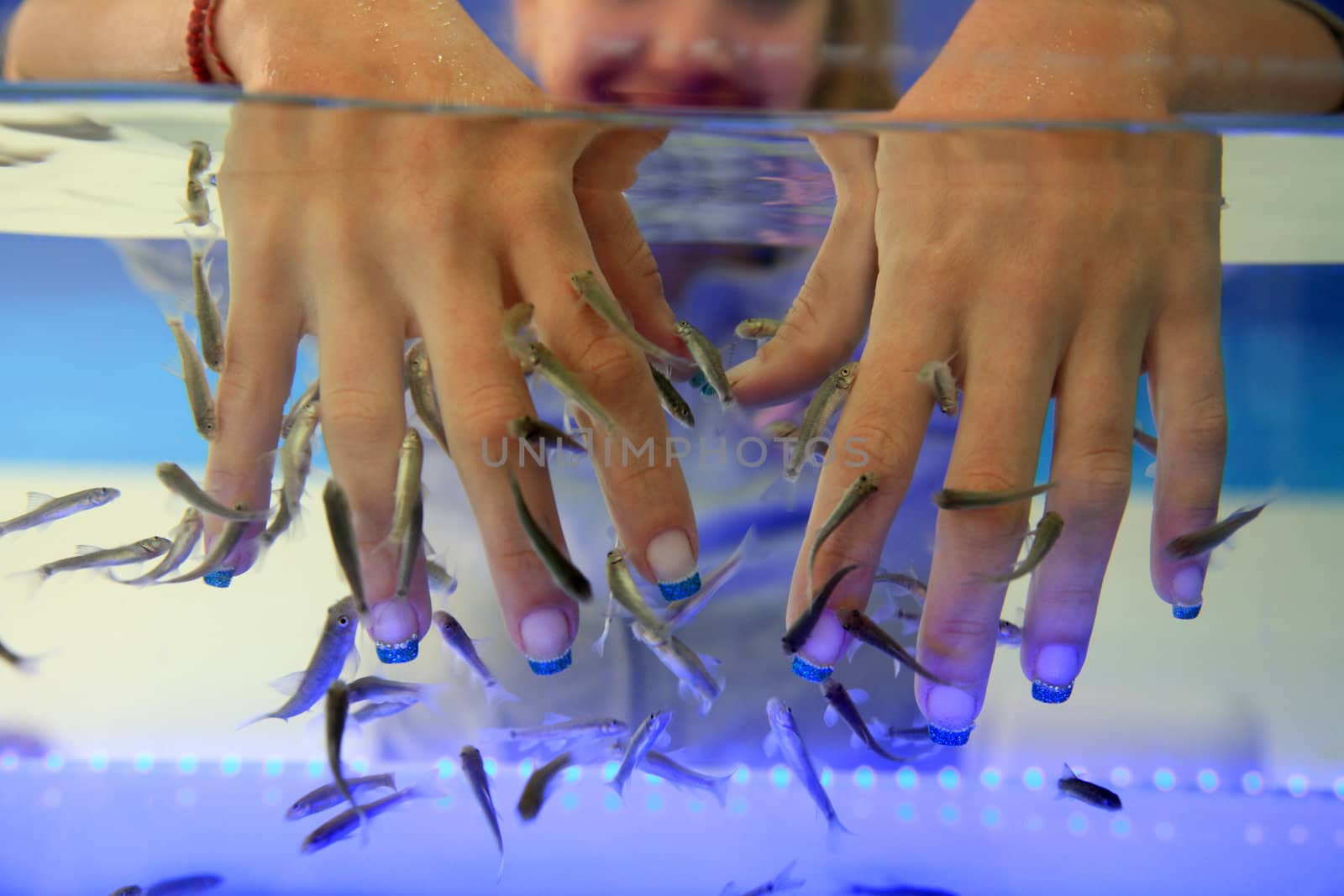 close-up of hands taking care at fish spa