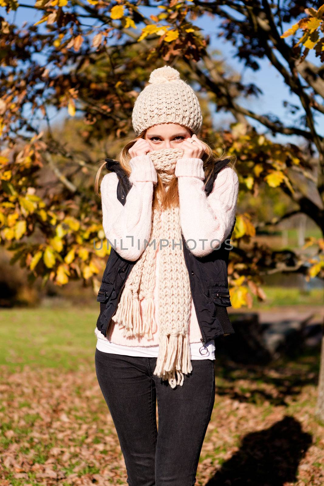 young woman in autumn sunshine outdoor in warm clothes lifestyle