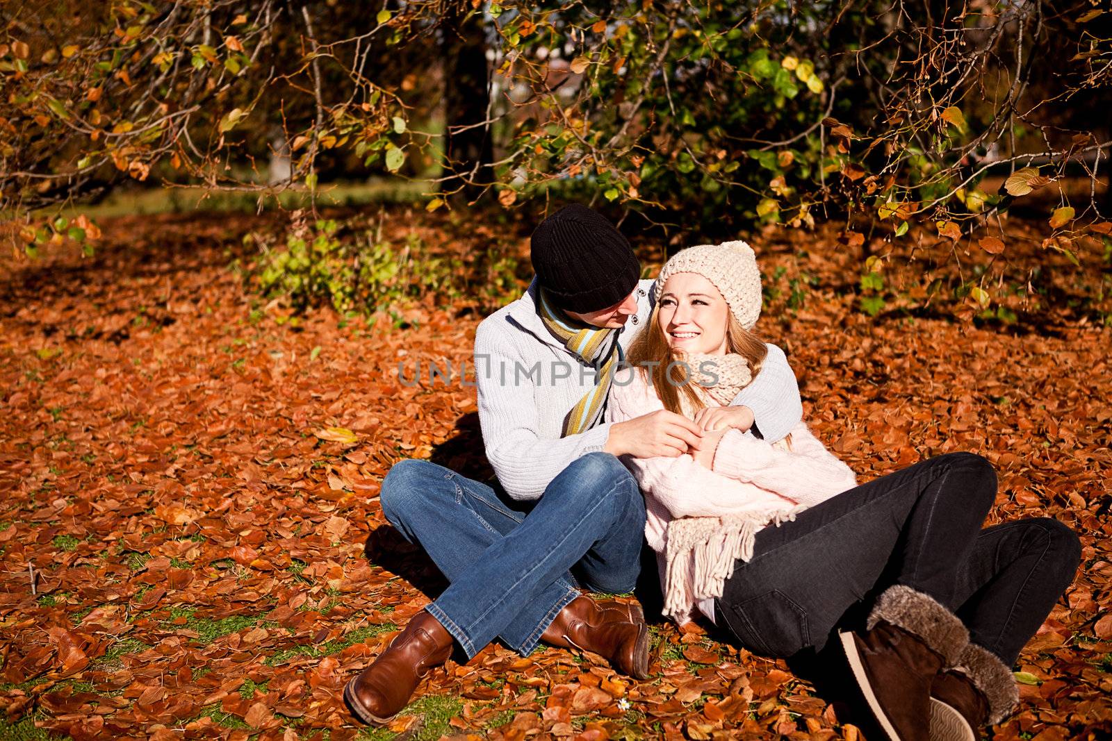 happy young couple smilin in autumn outdoor by juniart