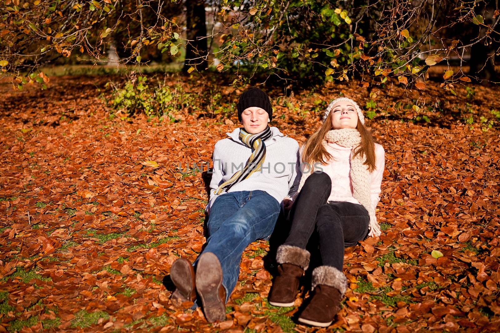 happy young couple smilin in colorful sunny autumn outdoor in park