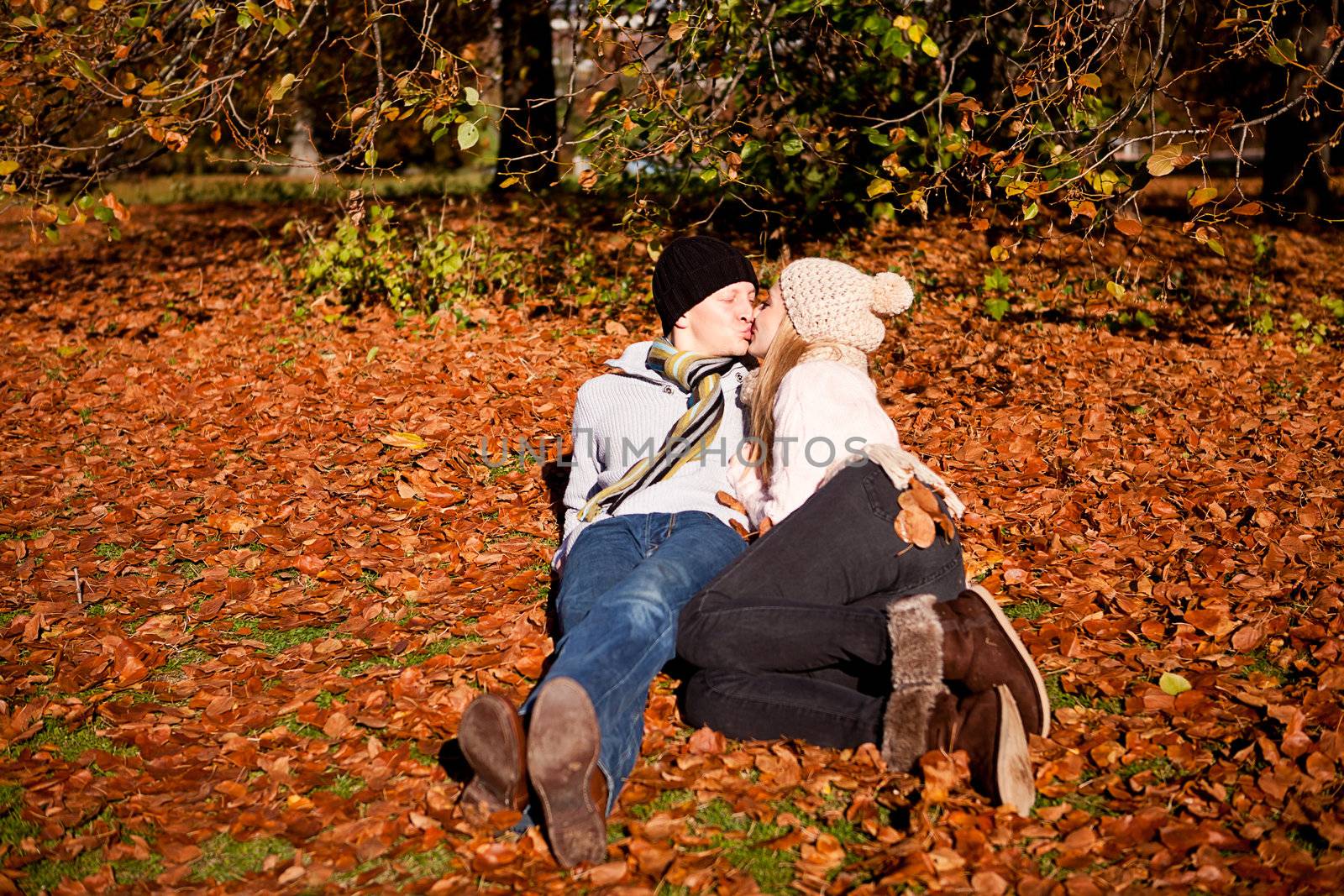 happy young couple smilin in colorful sunny autumn outdoor in park