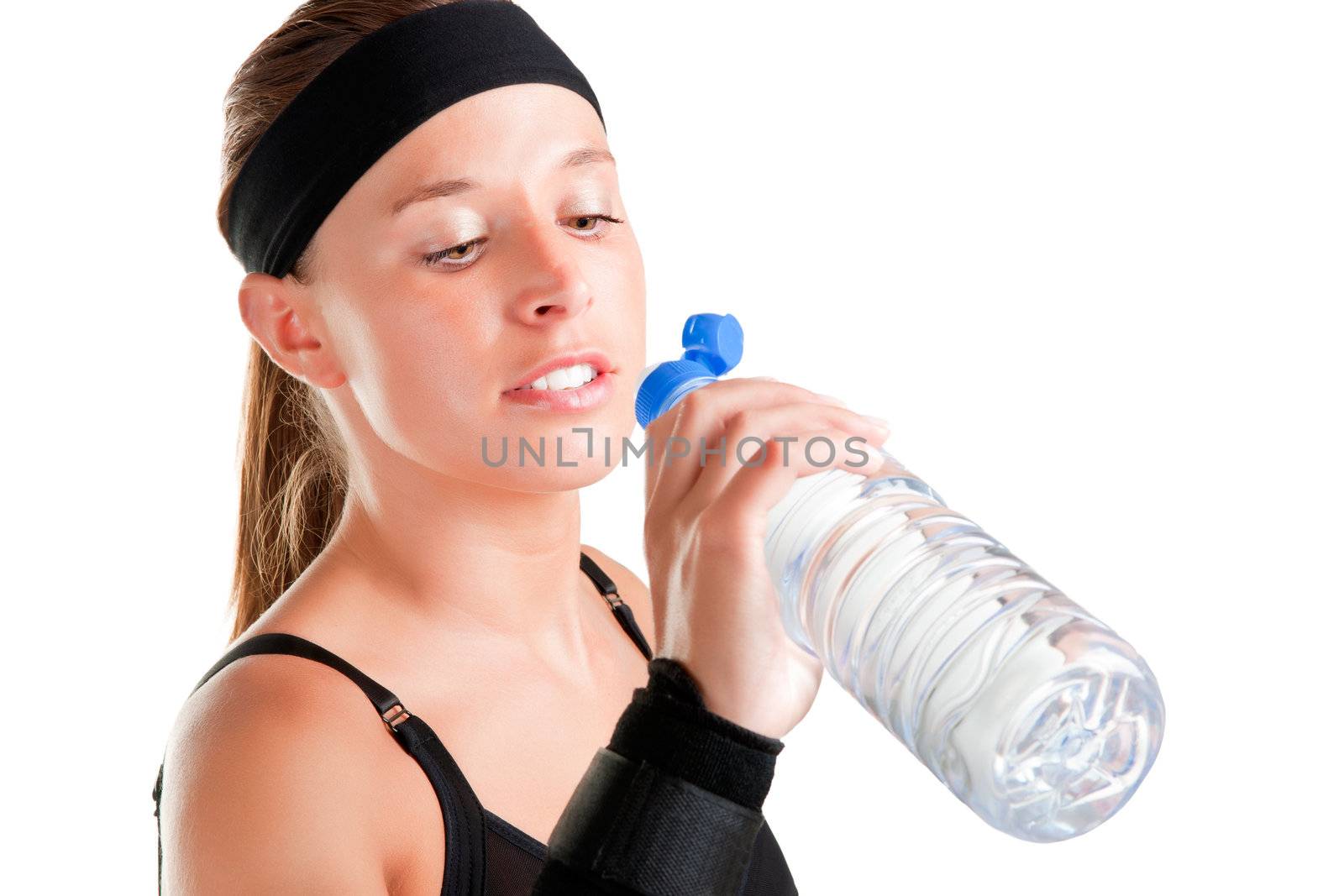Woman drinking water from a plastic bottle, isolated in white