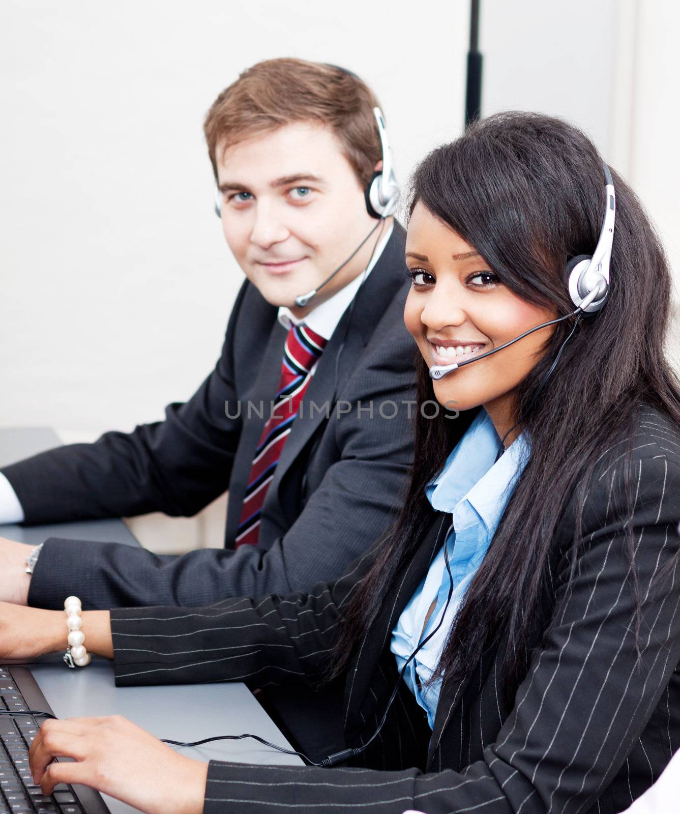 smiling callcenter agent with headset support hotline