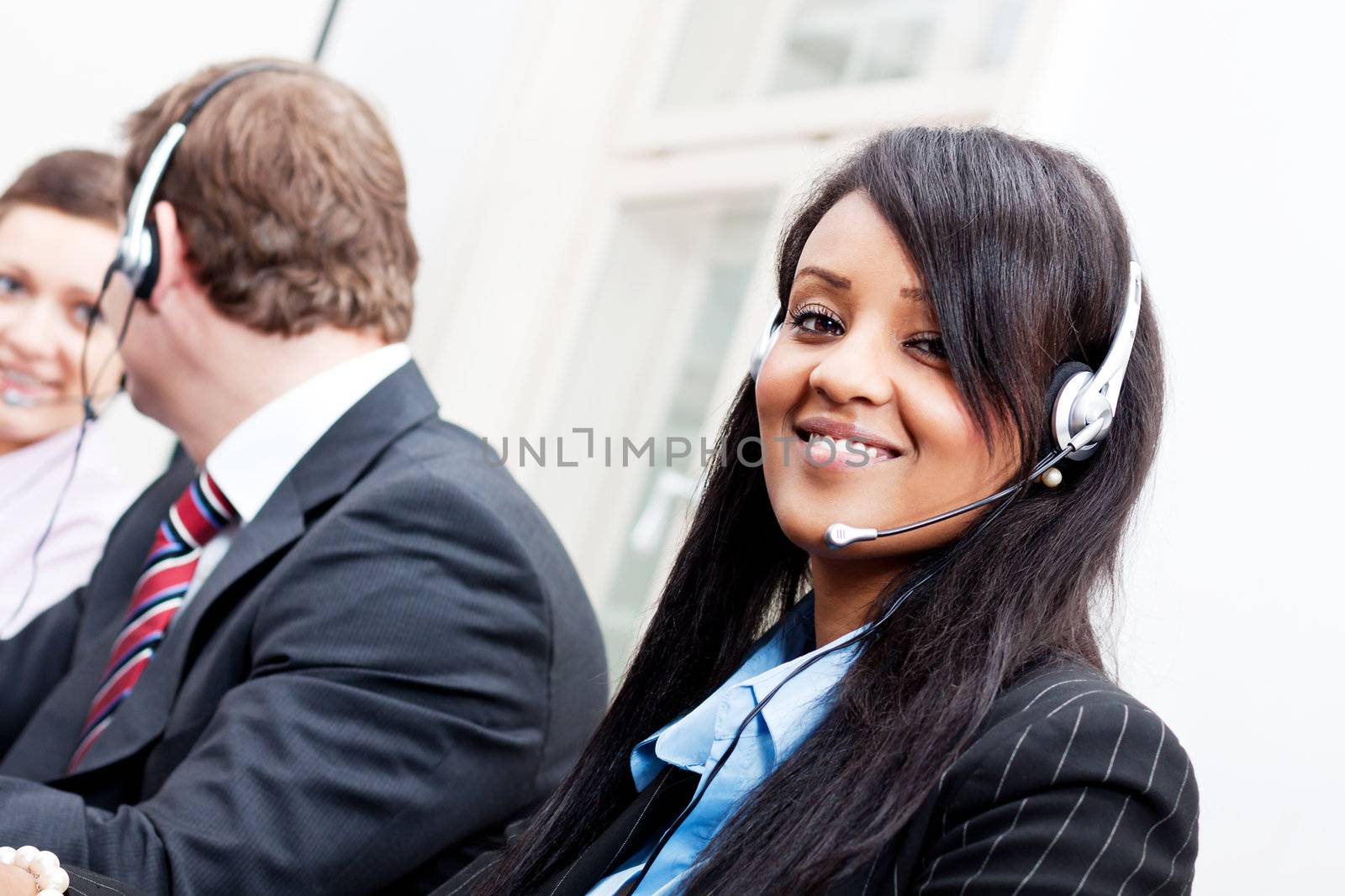 smiling callcenter agent with headset support by juniart