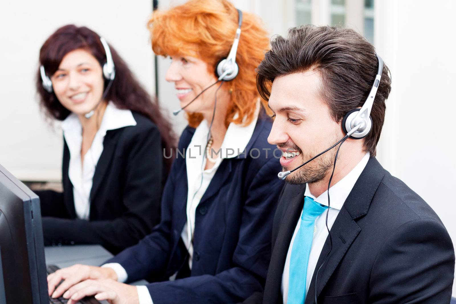 smiling callcenter agent with headset support hotline