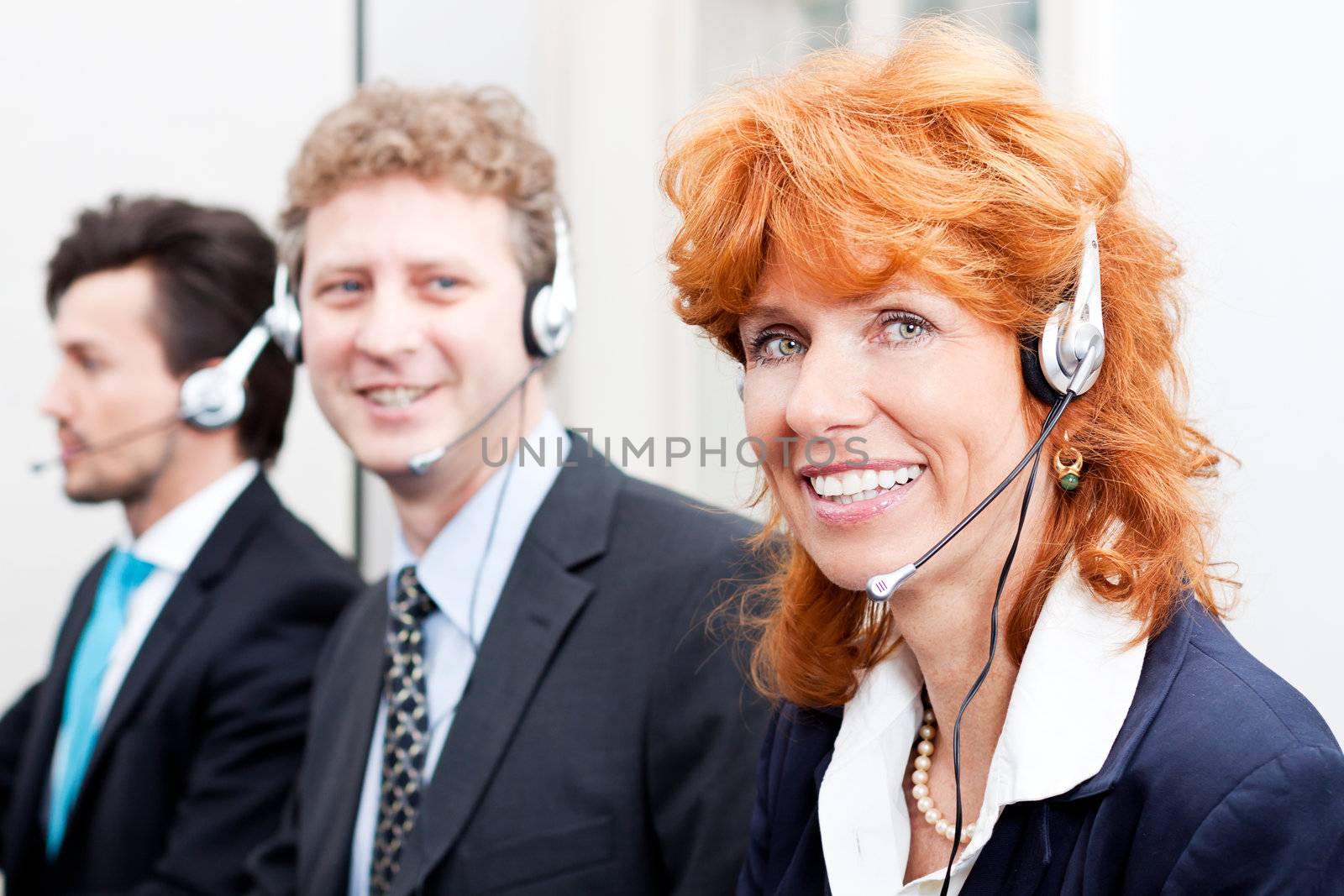 smiling callcenter agent with headset support by juniart