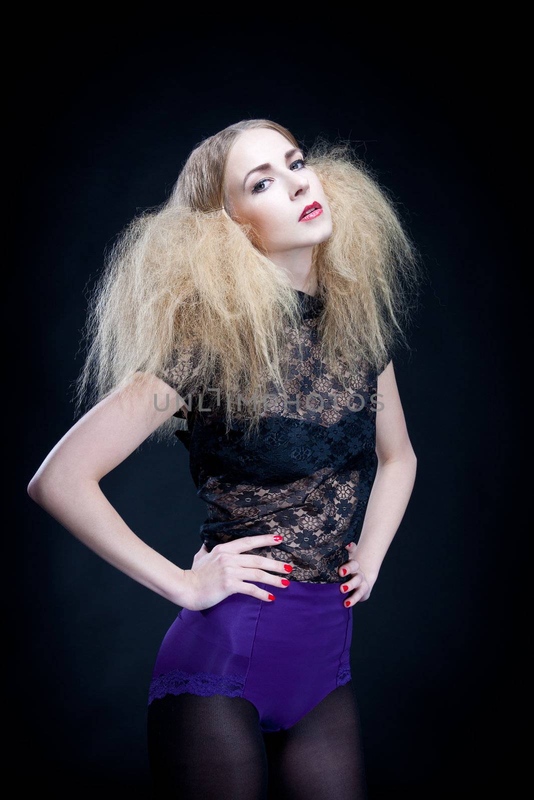 attractive blonde woman with big hair and modern styling fashion posing