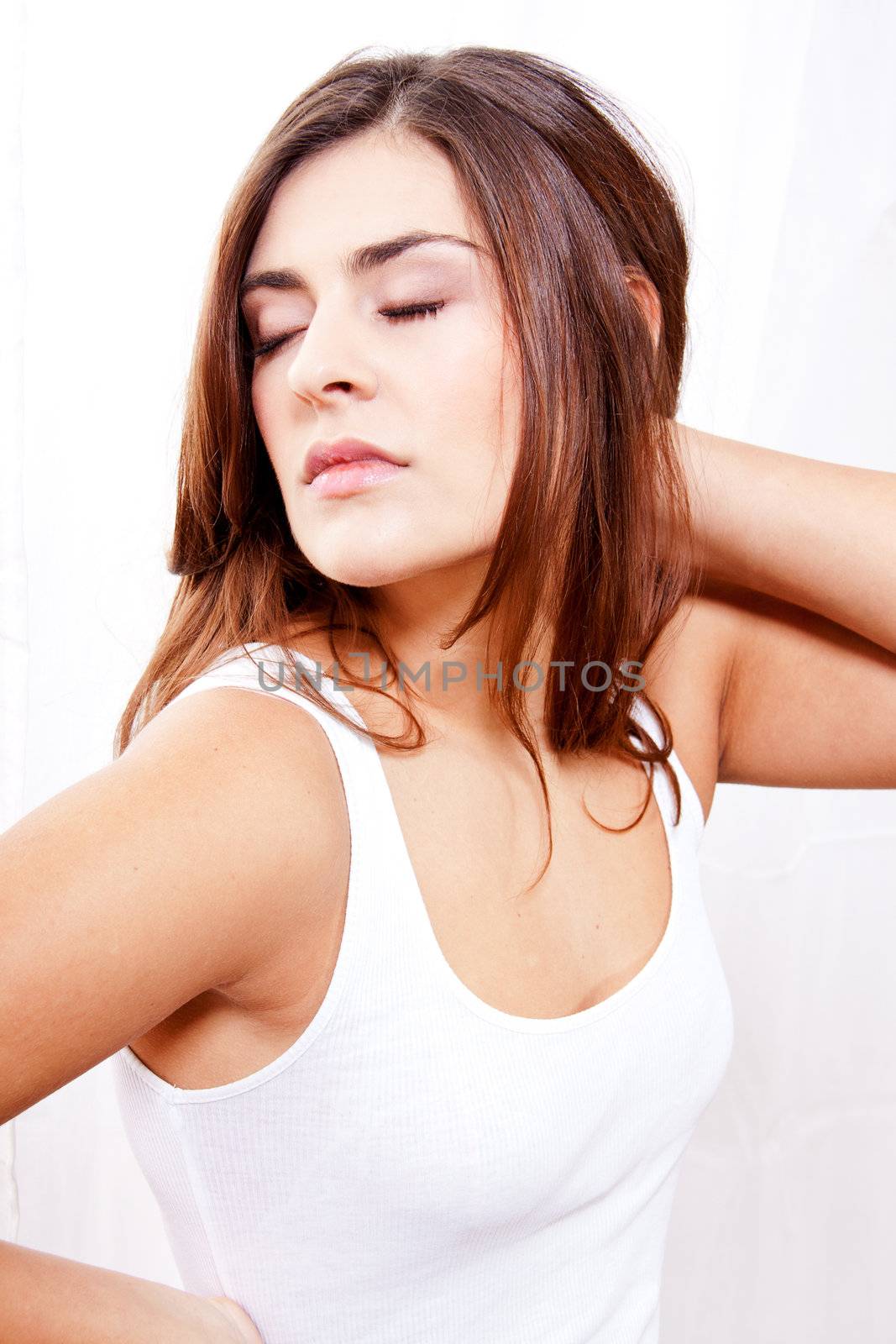 beautiful brunette woman in sunlight at window looking sensual portrait 