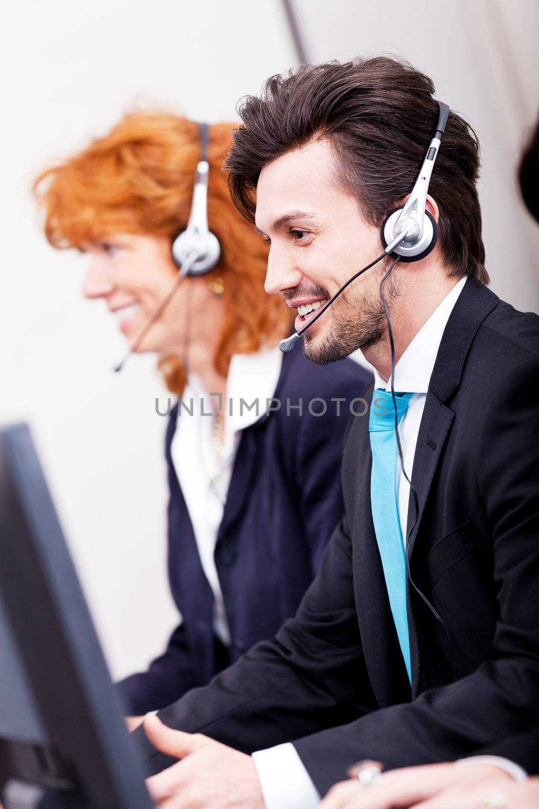 smiling callcenter agent with headset support hotline