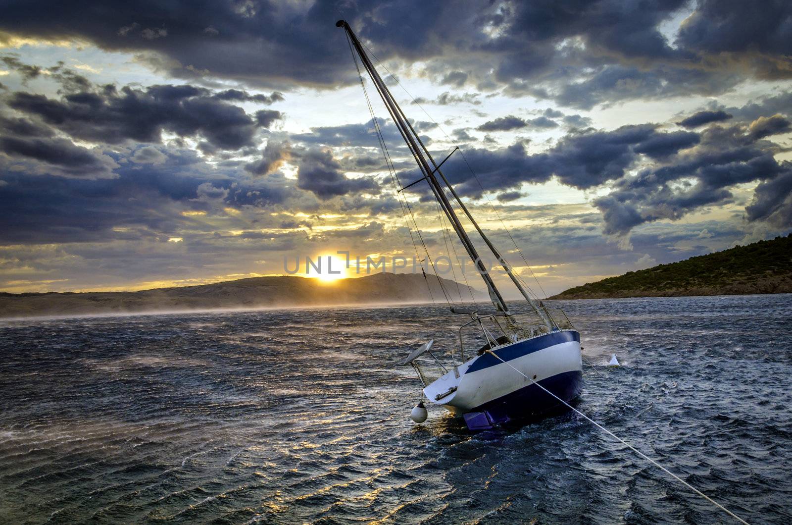 Sailboat is tilting in strong gusts of wind called Bora. Photo shows rare event of really strong summer Bora, this strength of Bora wind can ussualy be only seen in the winter time.