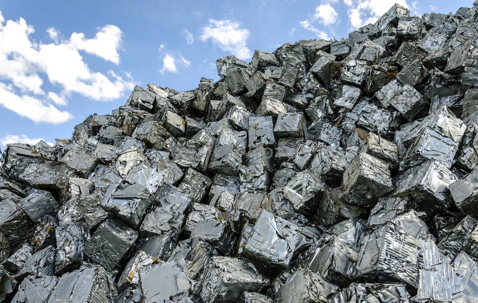 Pile of metal scrap cubes ready to be recycled.