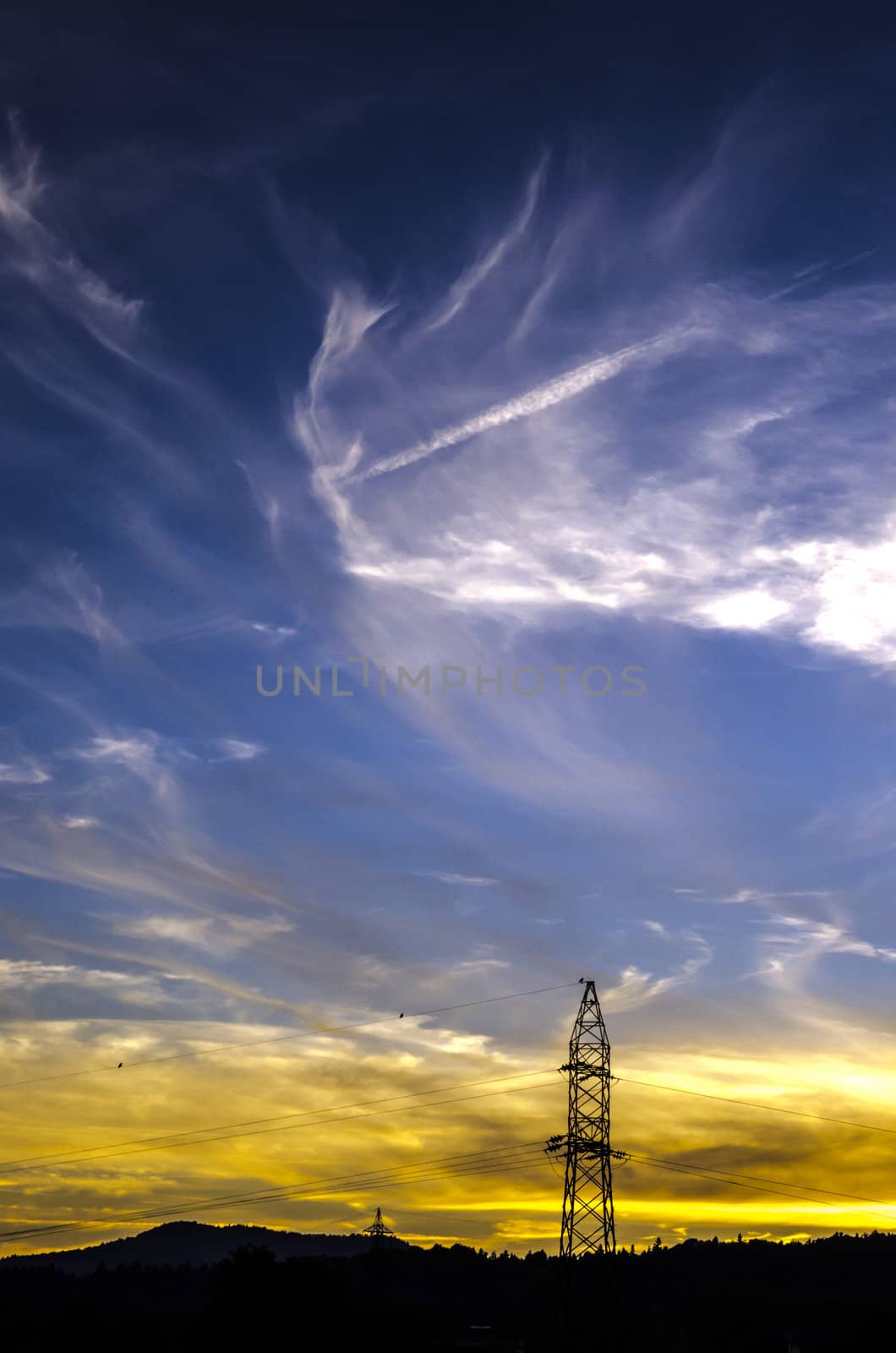 Power lines in a beautiful sunset environment.