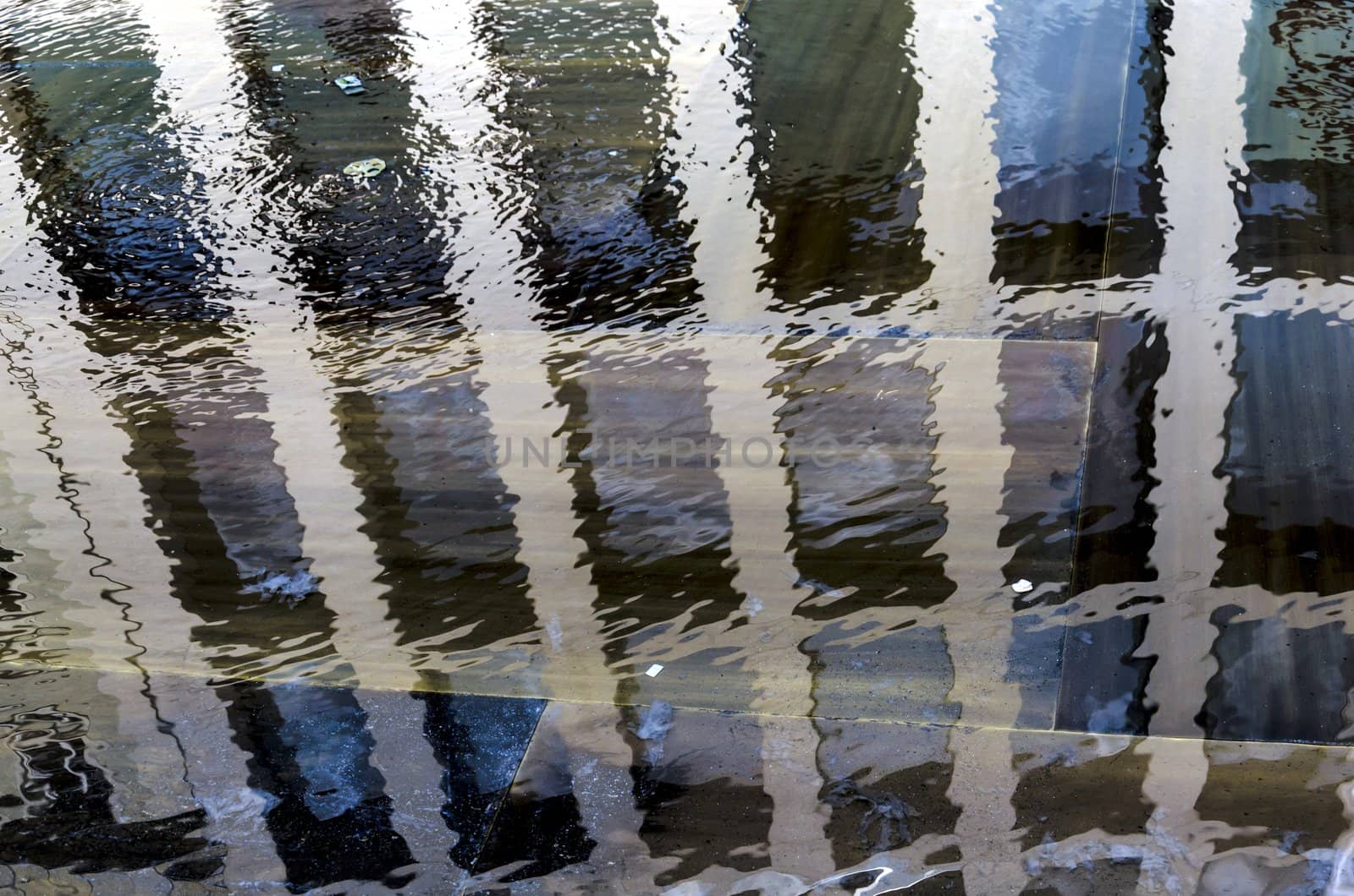 Modern building facade reflection in a fountain, Innsbruck, Austria.