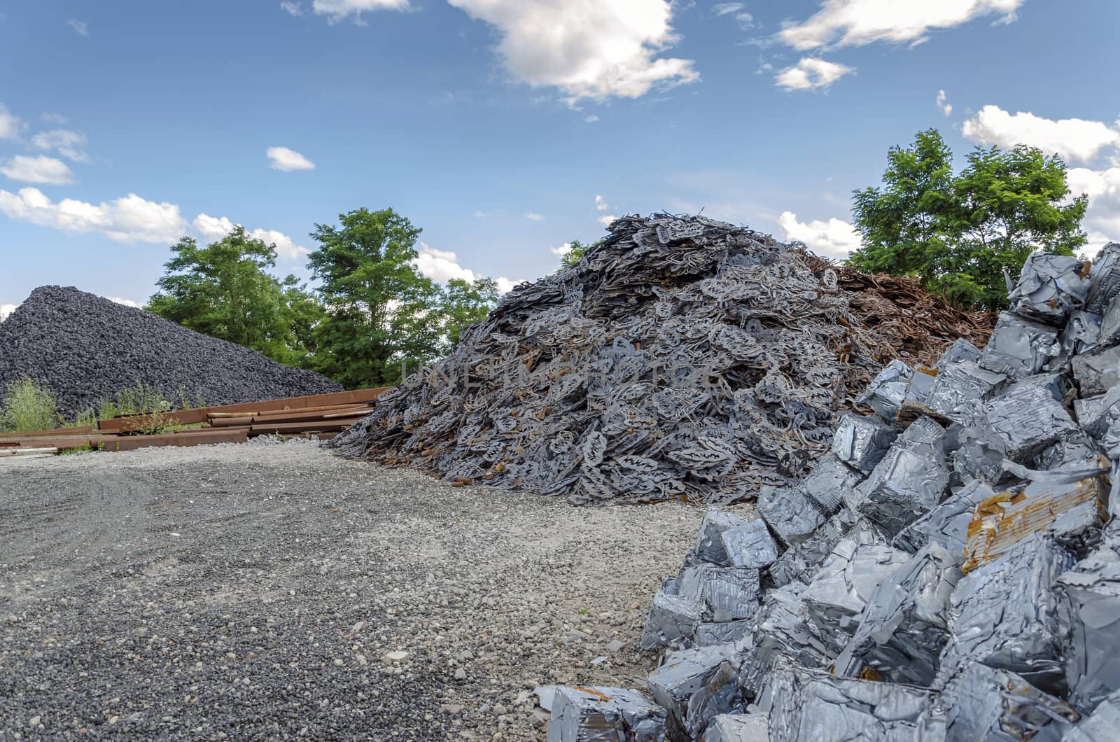 Scrapheap with metal waste piles ready to be recycled.