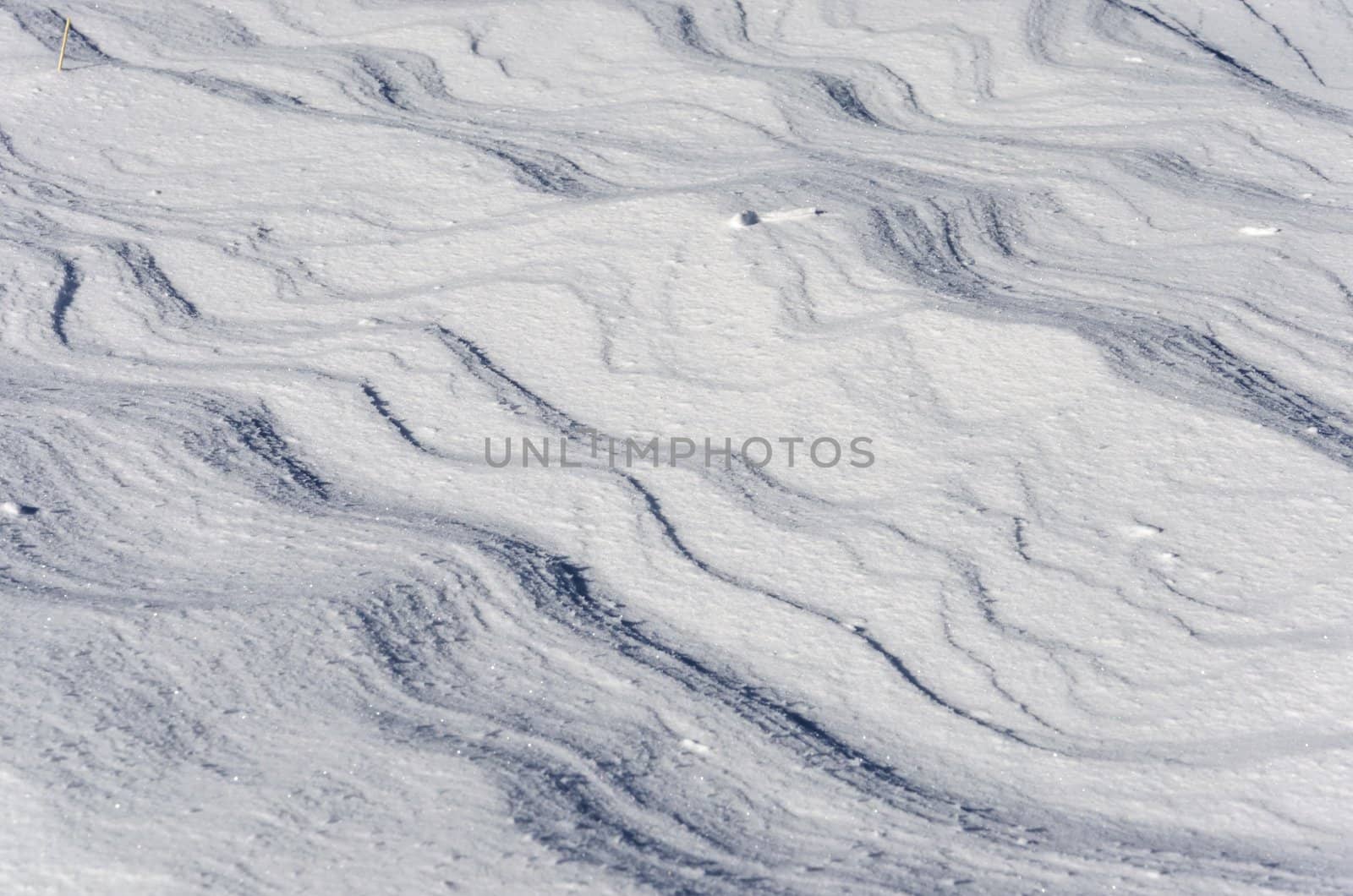 Snow pattern formed by blowing wind.