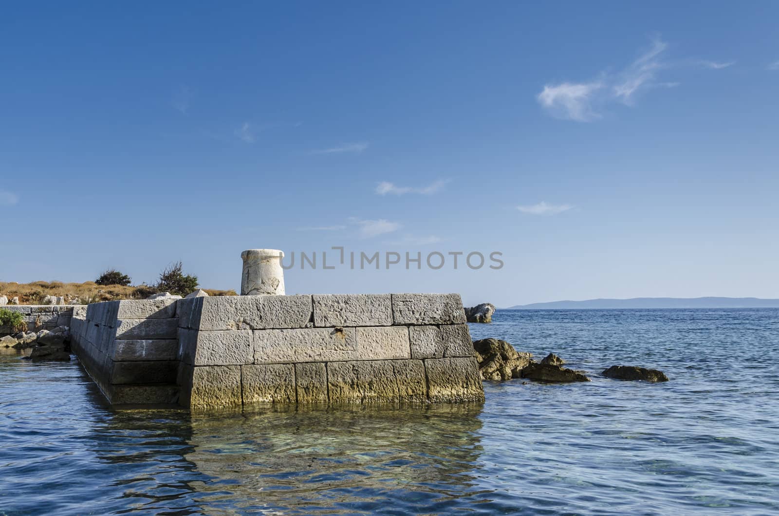 Remote stone pier on island Trstenik, Kornates, Croatia.