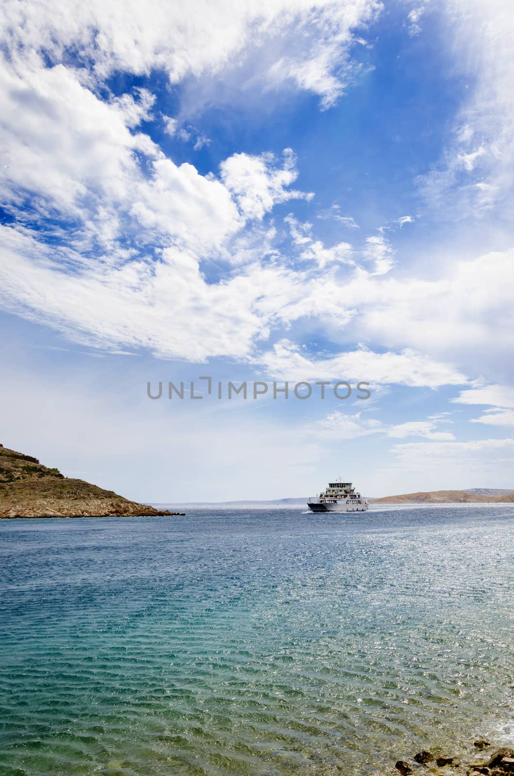 Small ferry aproaching on sunny and windy day in Stinica, Croatia.