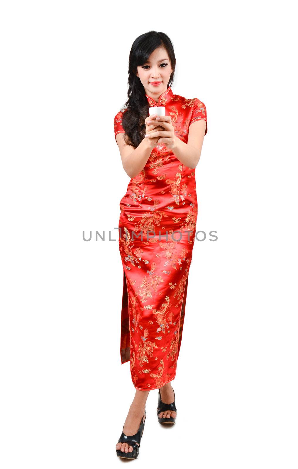 pretty women with Chinese traditional dress Cheongsam and drinking tea on white background