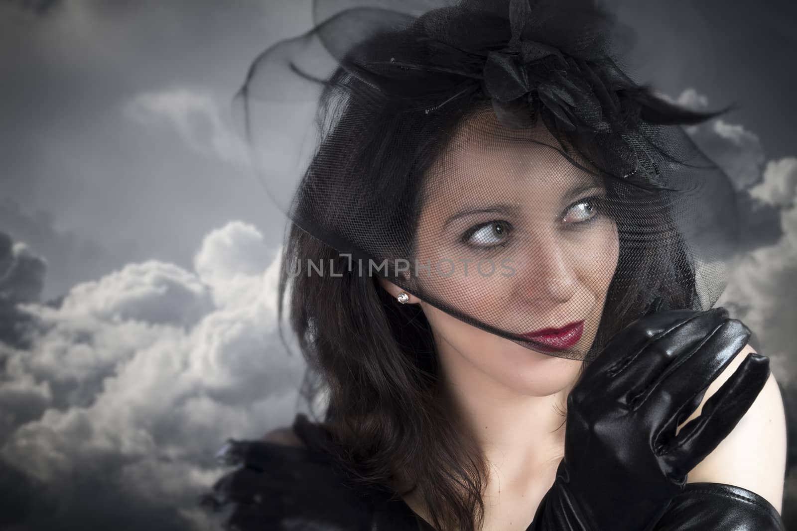 Portrait of young sexy woman in black veil on cloudy sky by FernandoCortes
