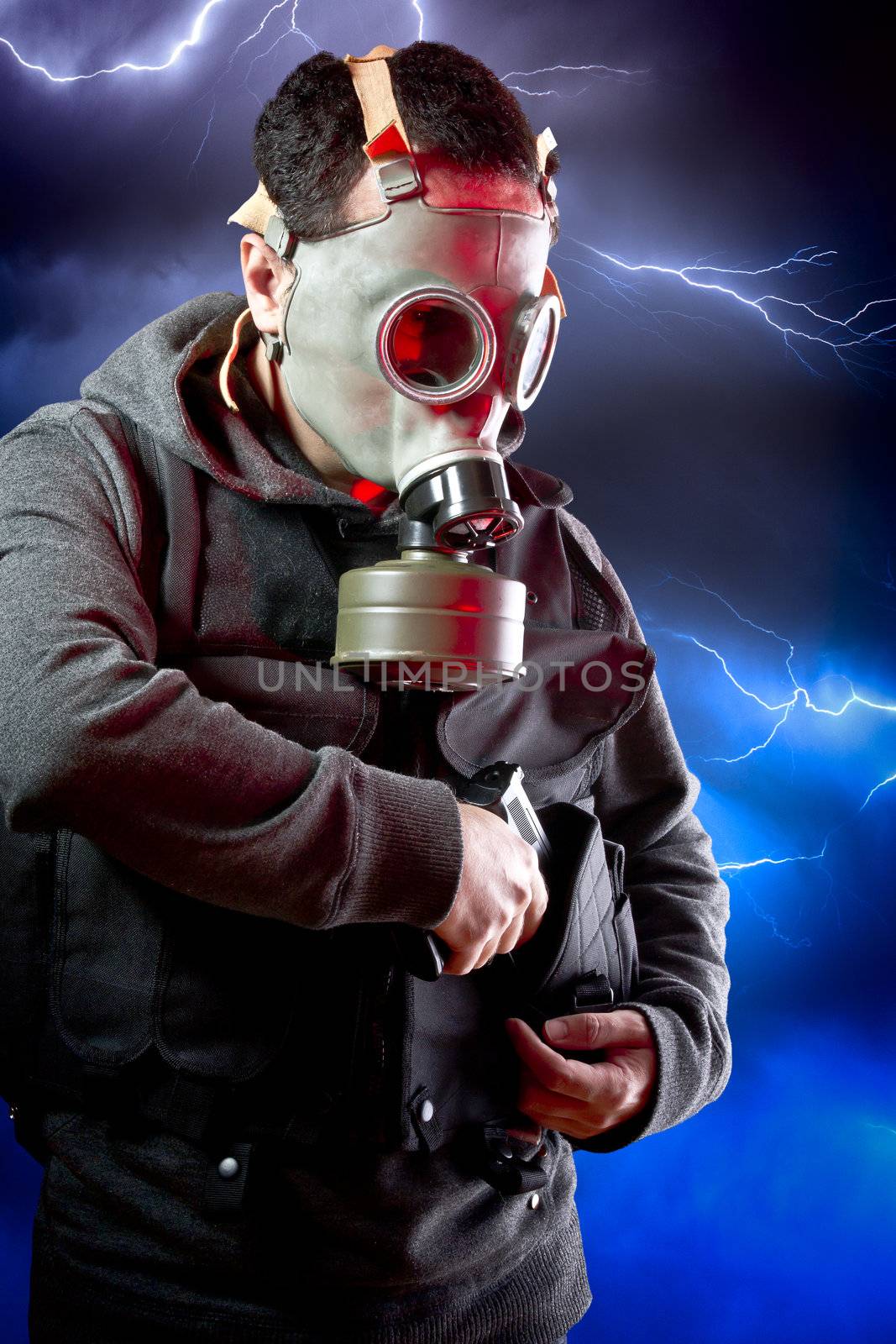 Man with long leather jacket and assault rifle over storm background