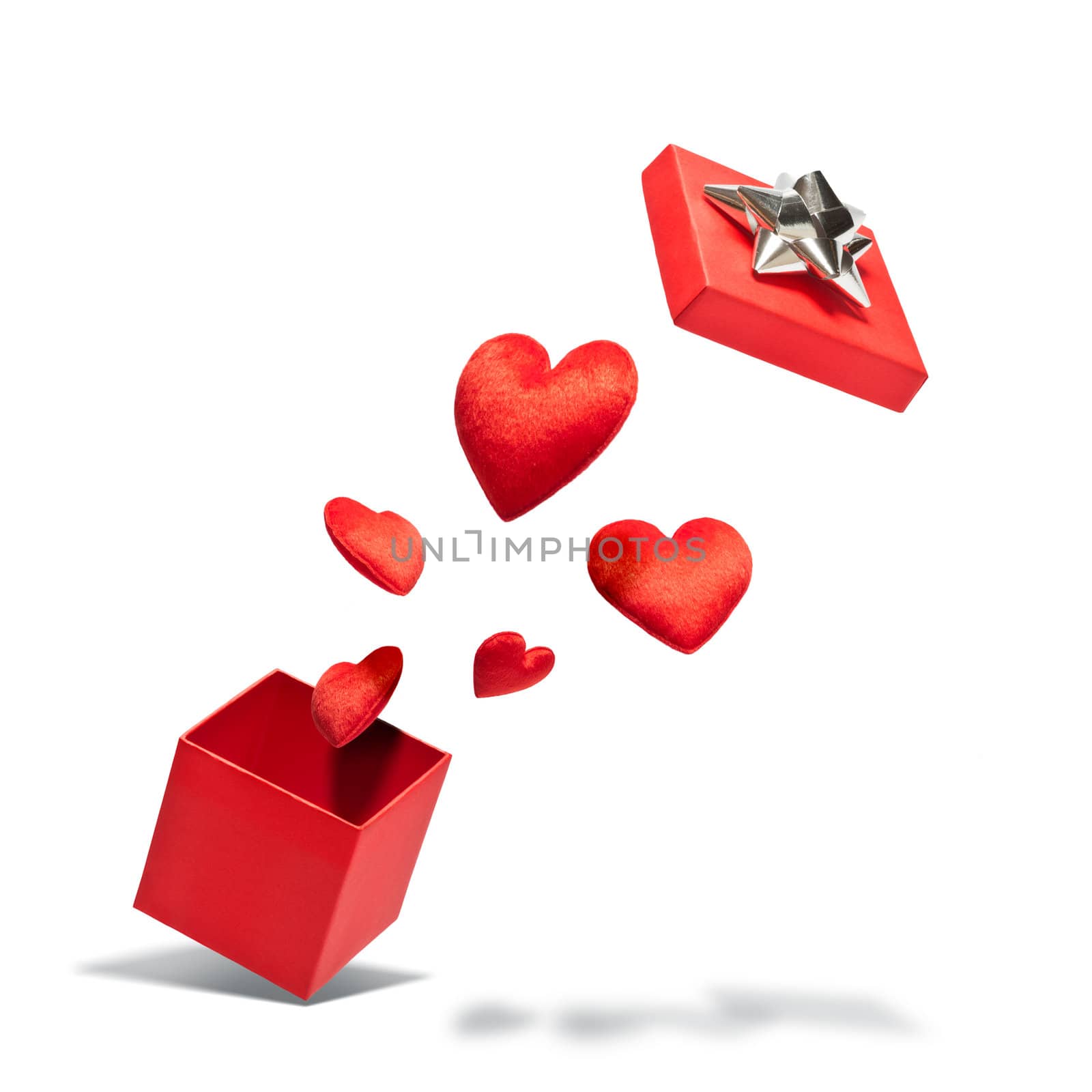 Opened gift box with flying hearts over white background