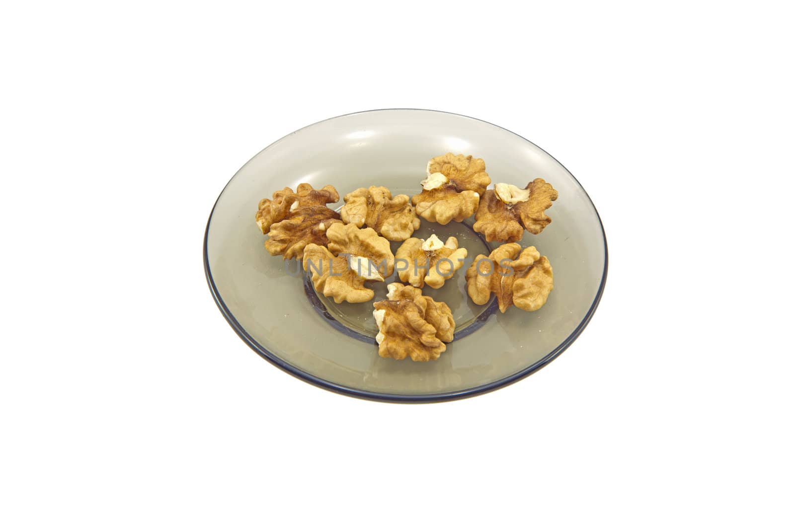 Some walnuts on a glass plate isolated on a white background