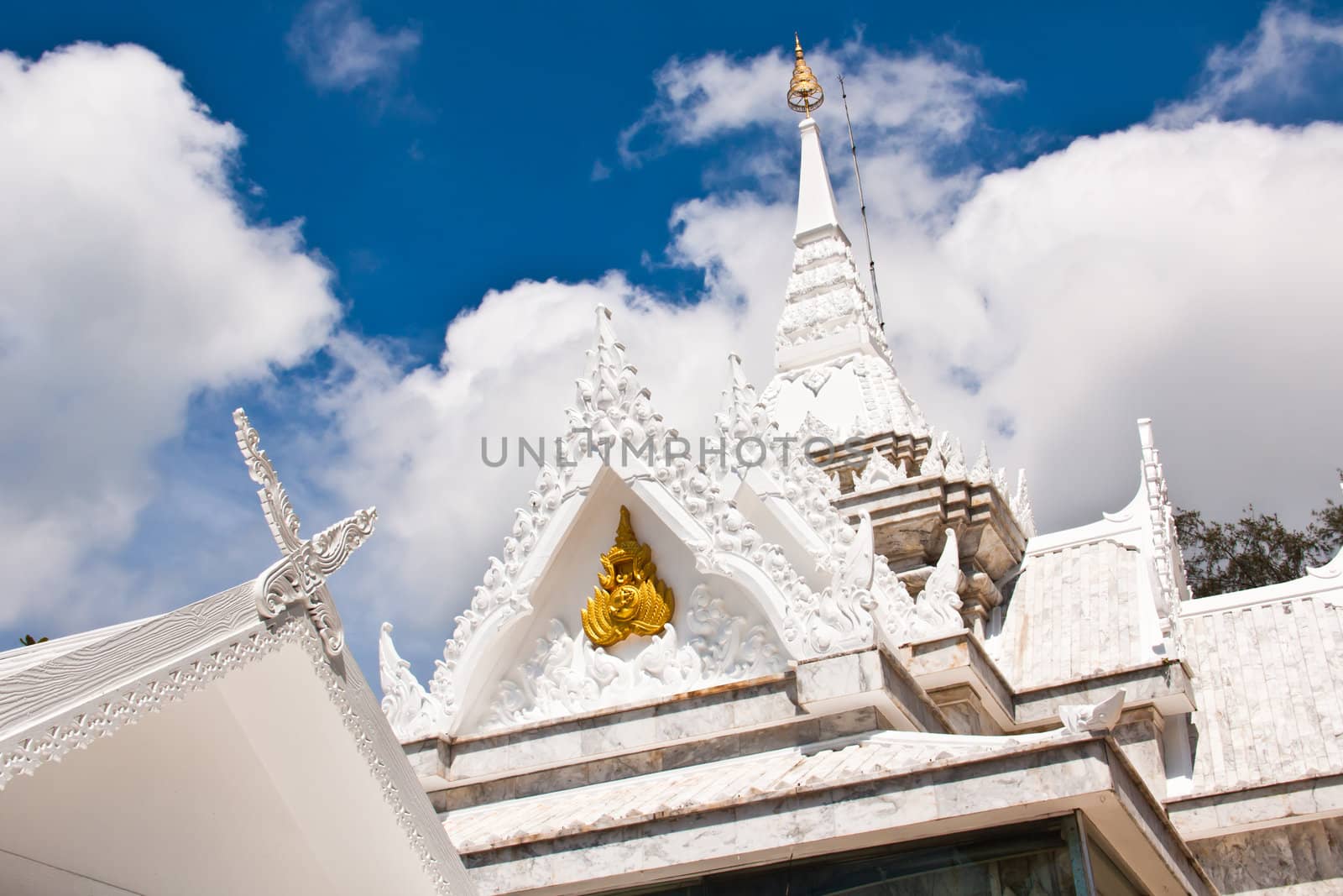 Buddhist temples in Thailand. The top of the roof is decorated with white stucco.