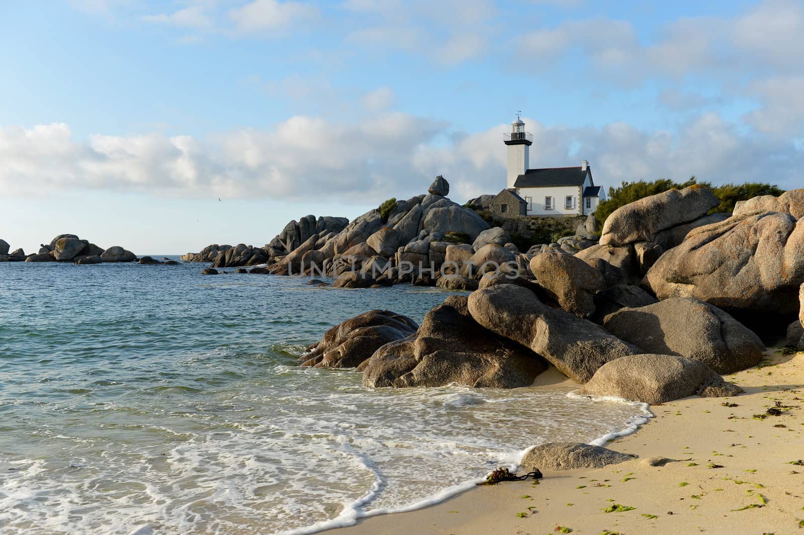 Lighthouse on the background of the ocean and cliffs