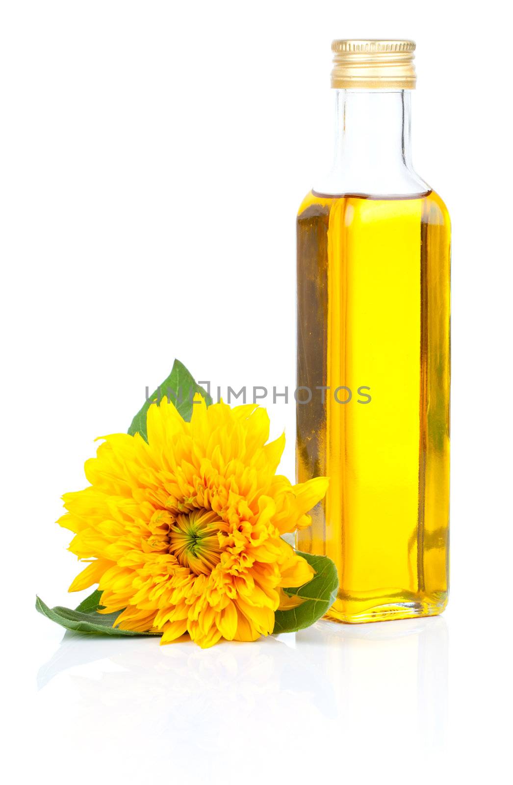 oil in glass bottle and sunflowers, isolated on white