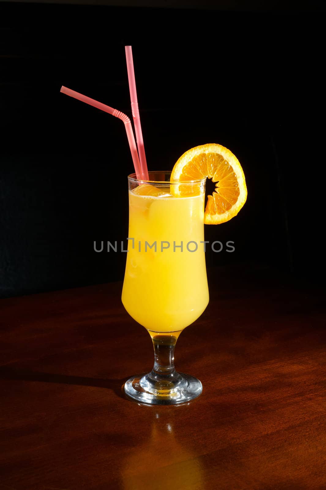 orange juice on a cocktail glass with a slice of orange