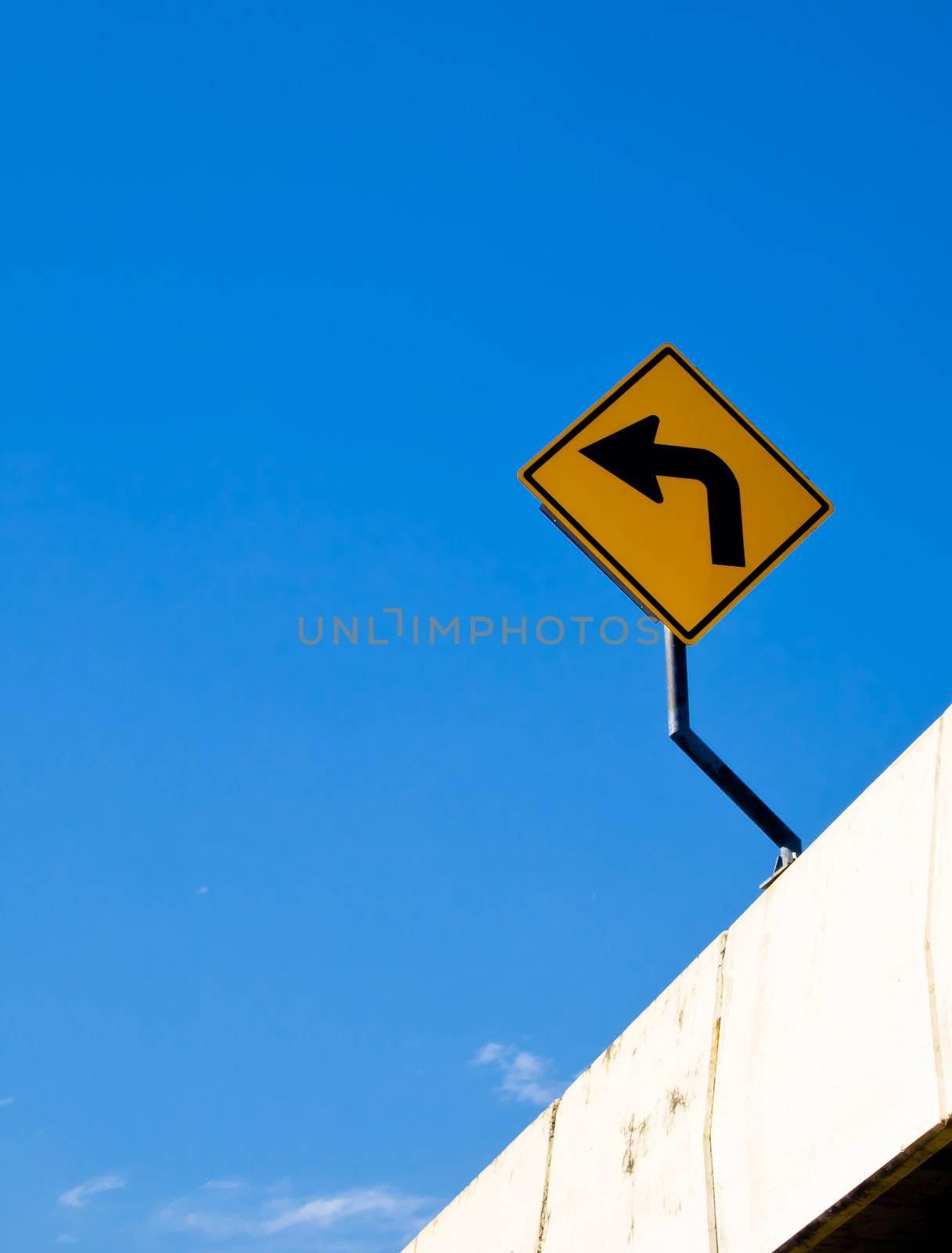 Turn left sign with blue sky by gjeerawut