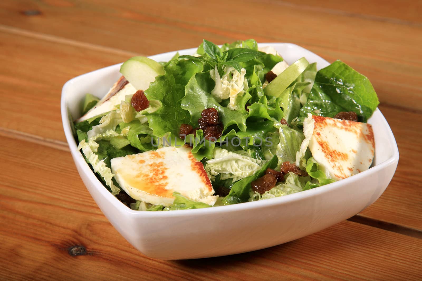 close up of a green salad with cheese and green apple