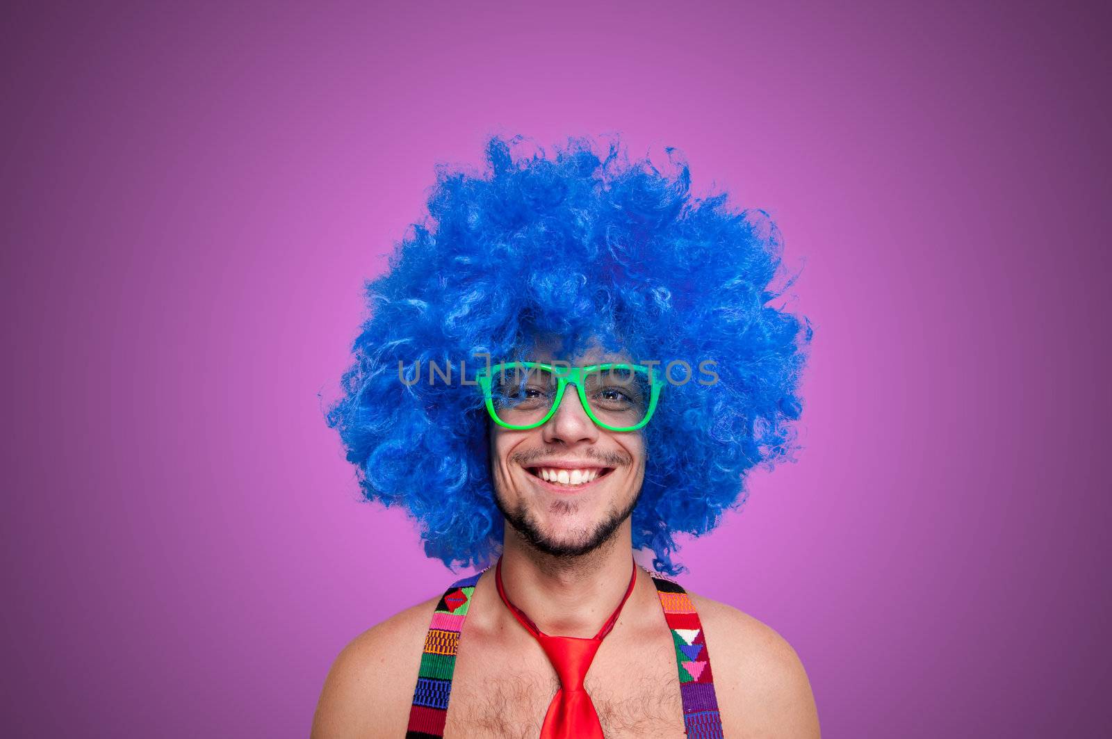 Funny guy naked with blue wig and red tie on green backgrund