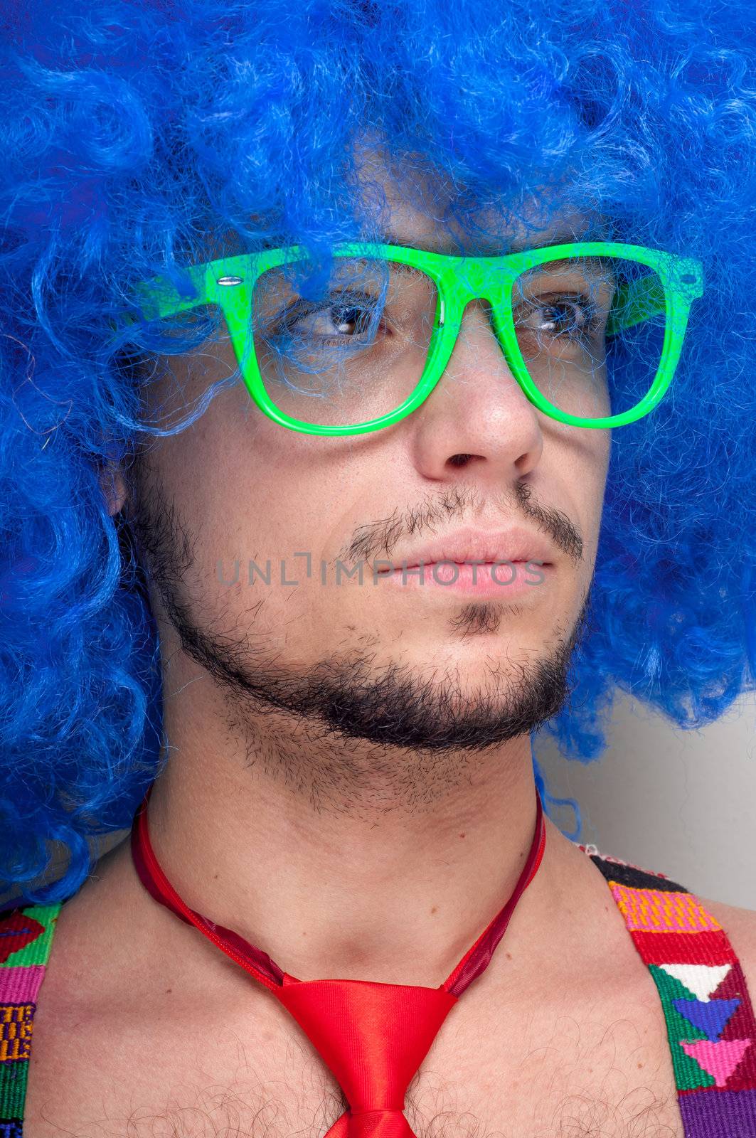 Funny guy naked with blue wig and red tie on green backgrund