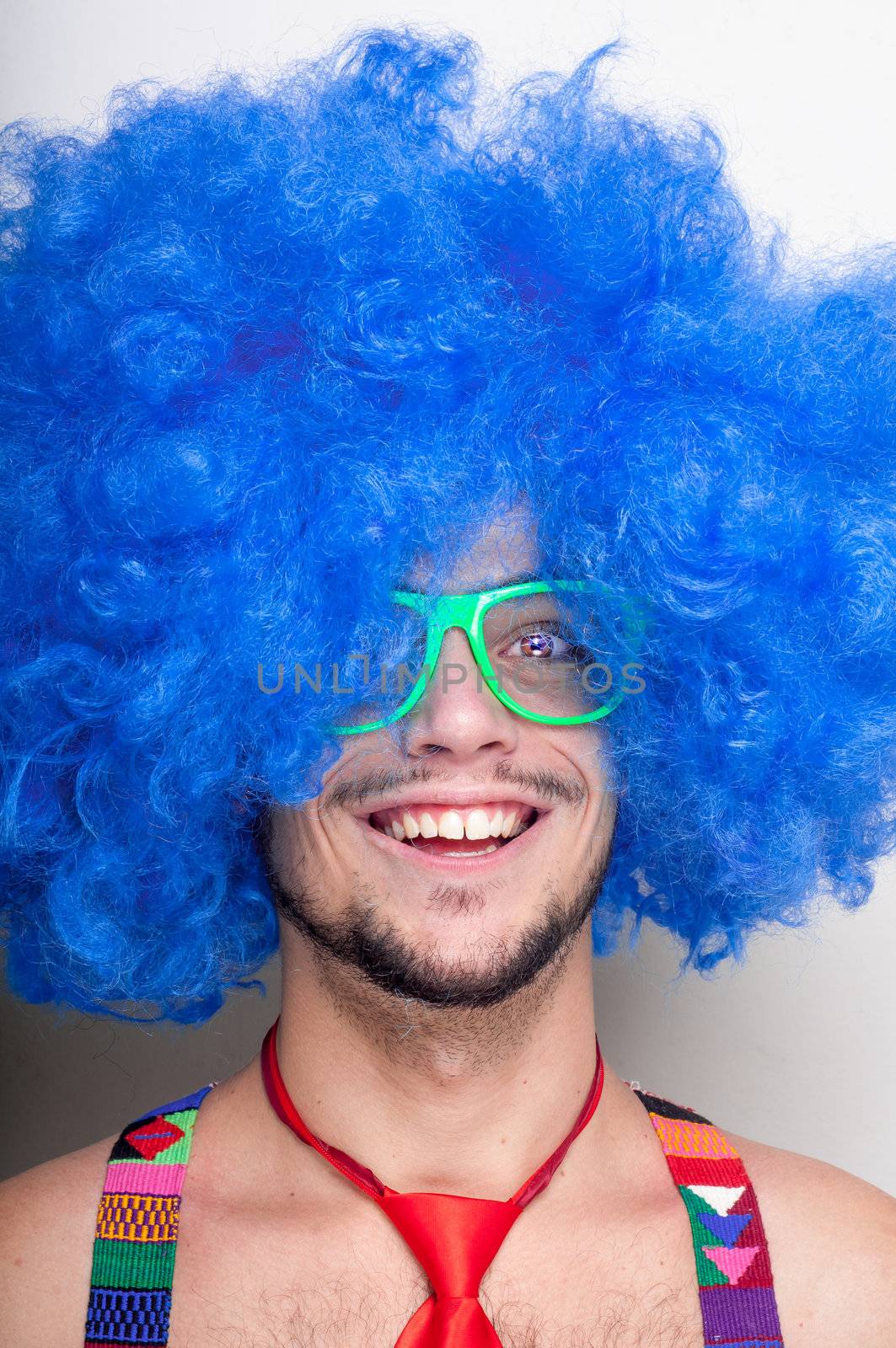 Funny guy naked with blue wig and red tie on green backgrund