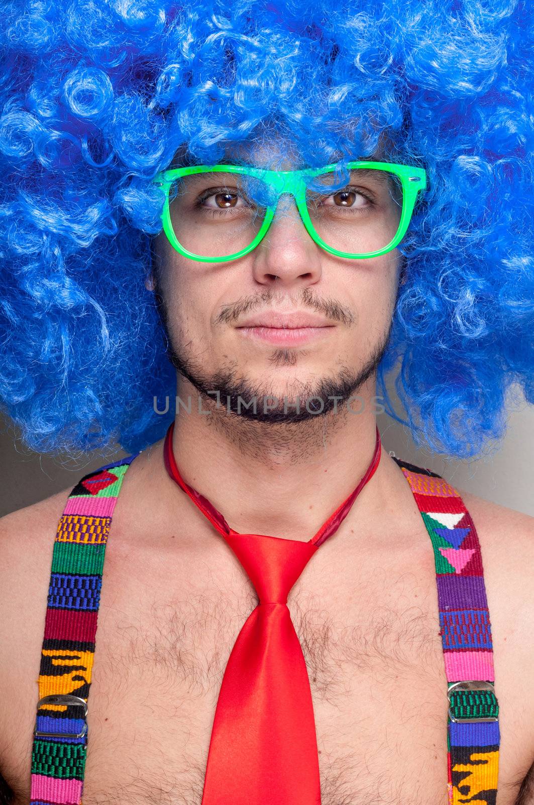 Funny guy naked with blue wig and red tie on green backgrund