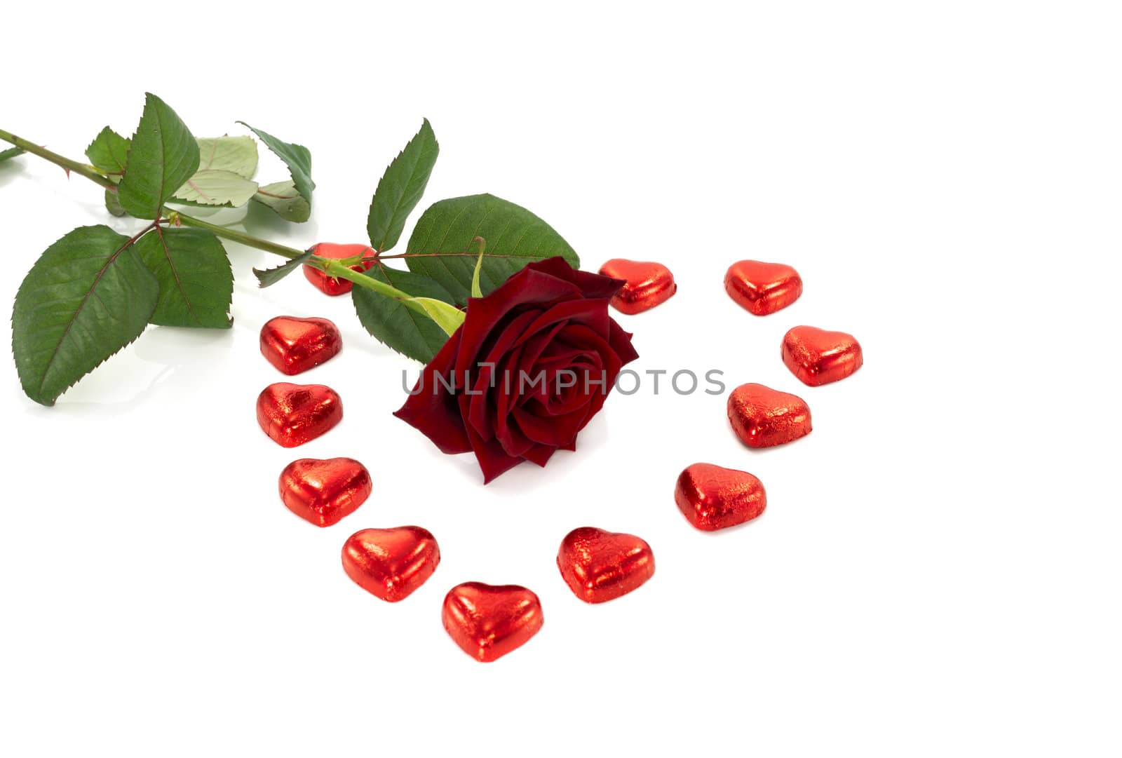 red rose and heart shape chocolate isolated on white