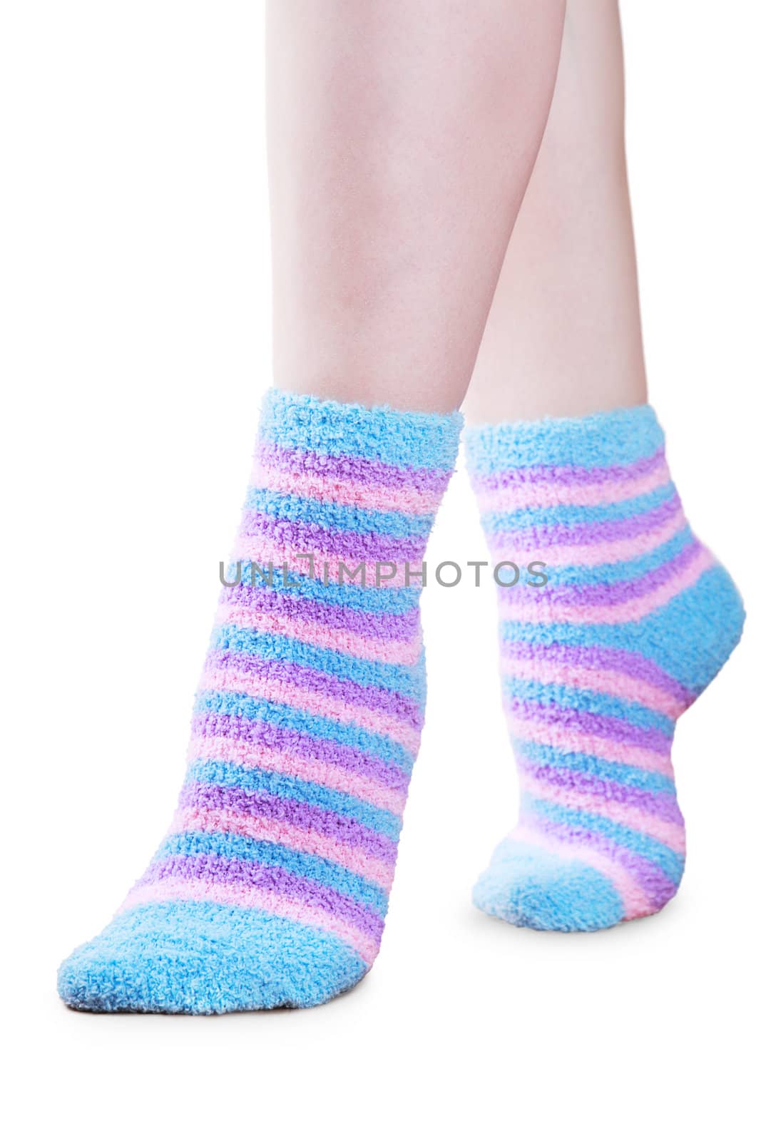 Woman legs in fluffy colorful striped socks ovwe white background