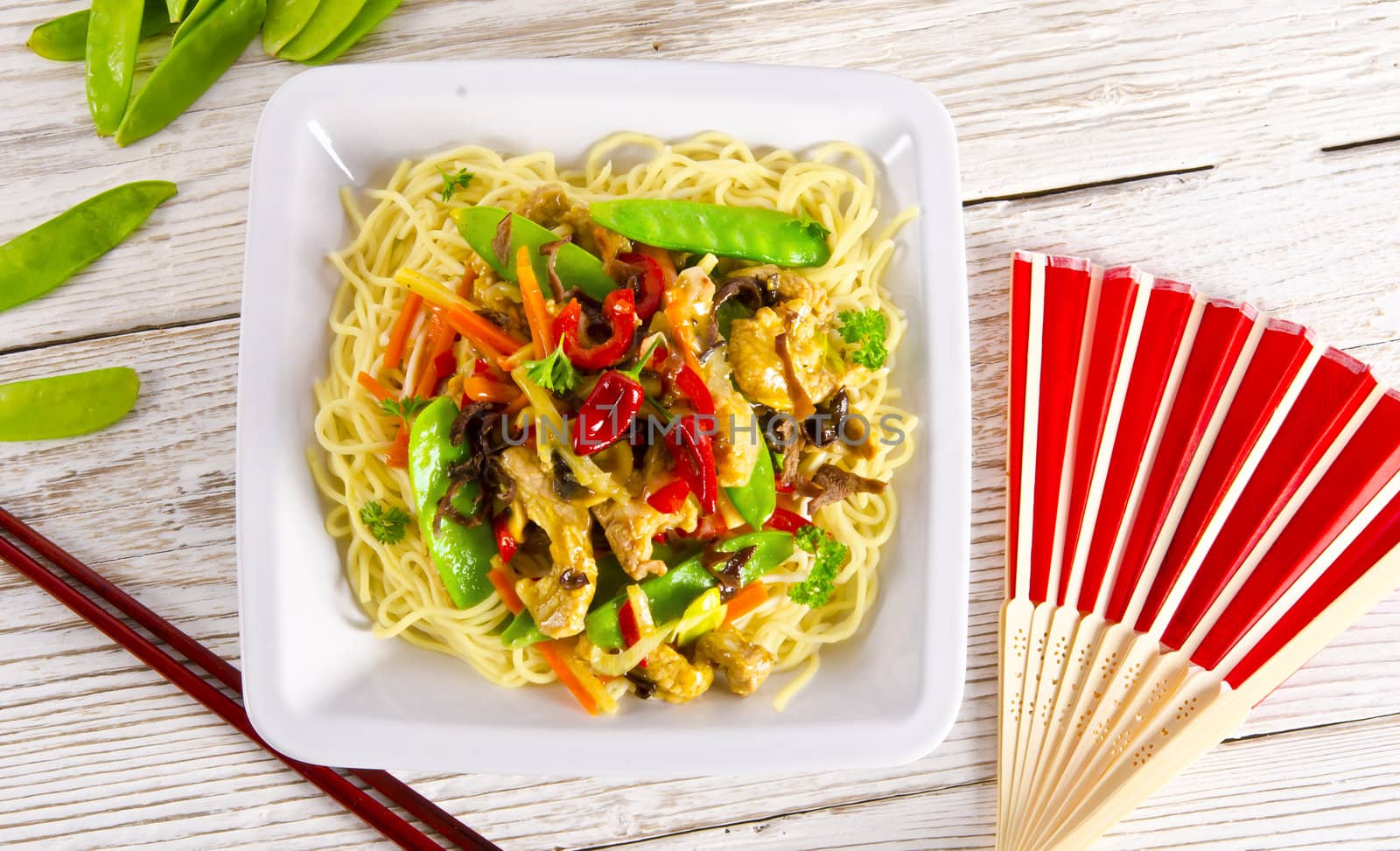 Noodles with pork and vegetables in plum sauce