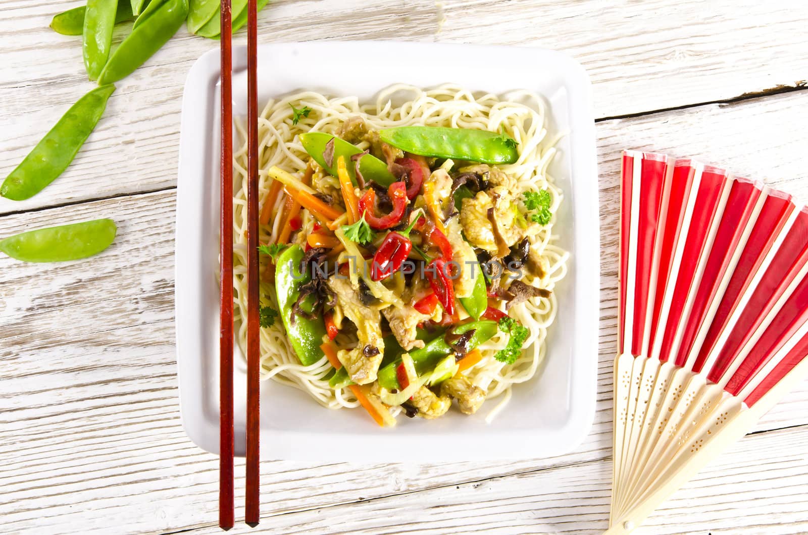 Noodles with pork and vegetables in plum sauce