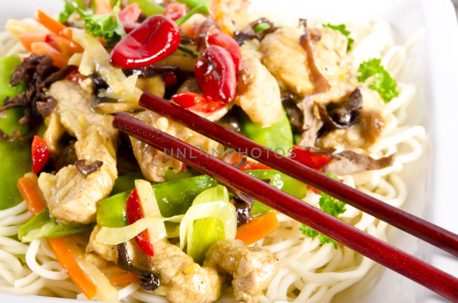 Noodles with pork and vegetables in plum sauce