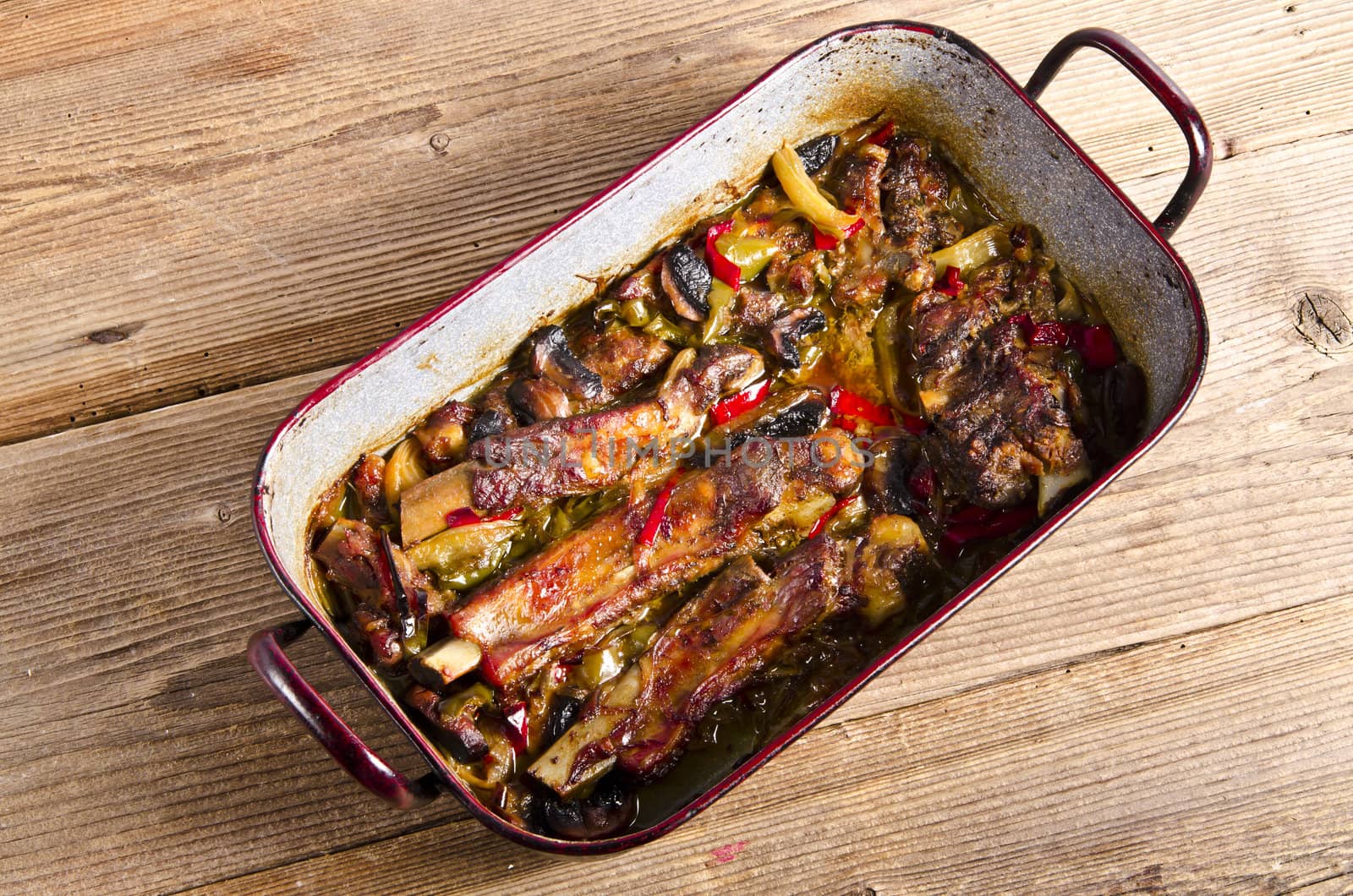 roasted ribs in old frying pan by Darius.Dzinnik