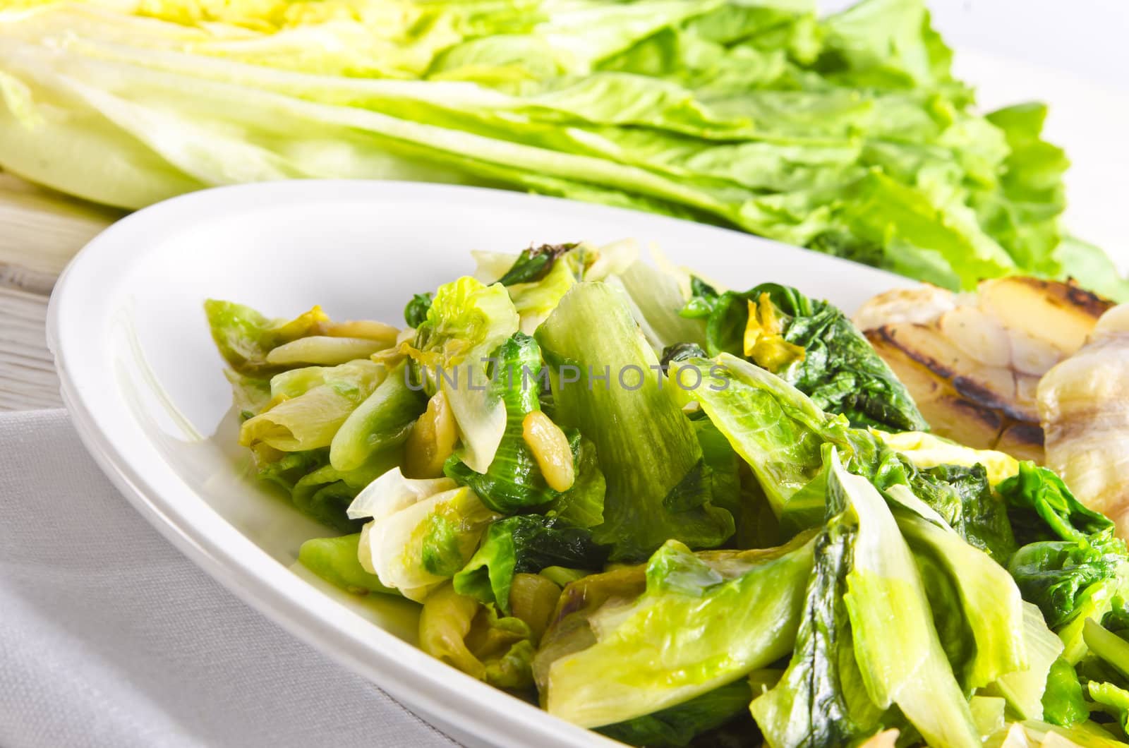 baked Romaine lettuce with garlic and pine cores