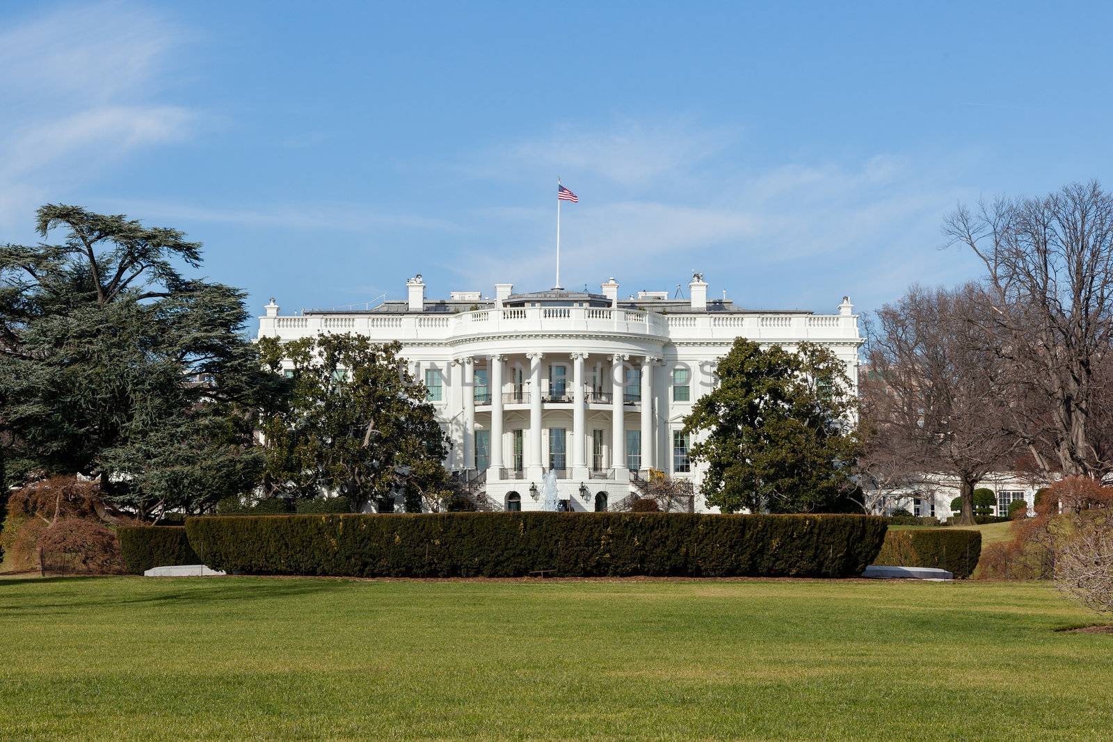 The White House in Washington DC against Sunny Blue Sky on Winter Day