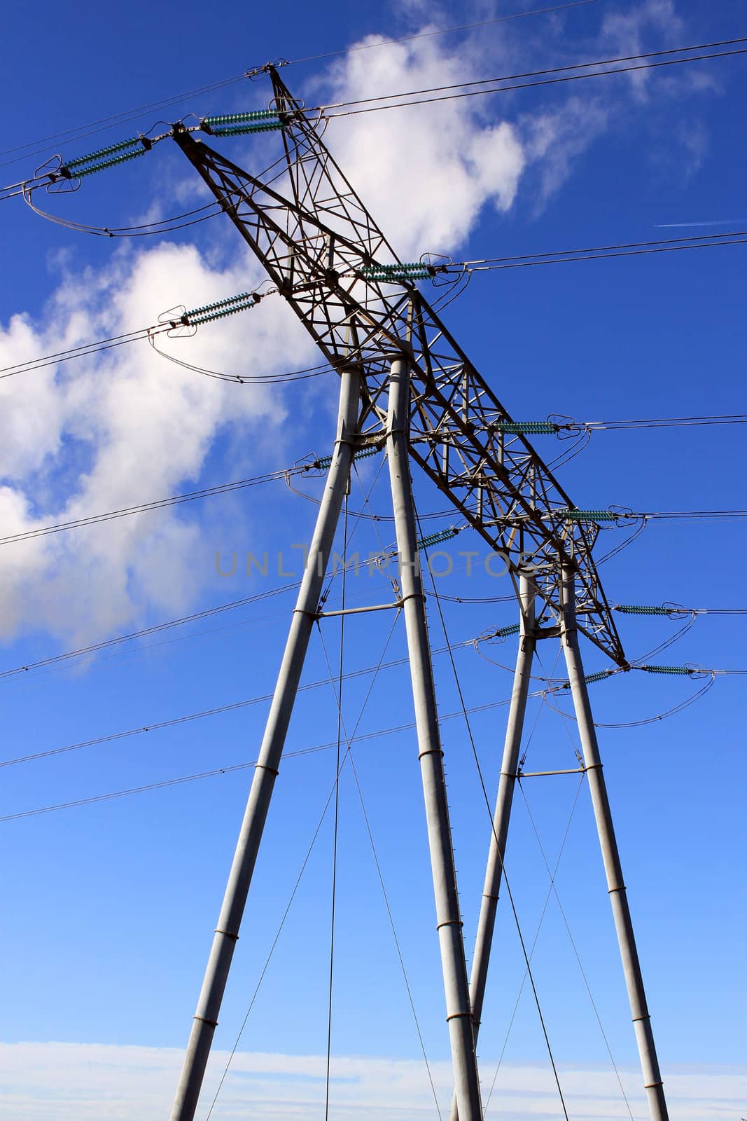 An electrical pylon against blue sky for nuclear energy