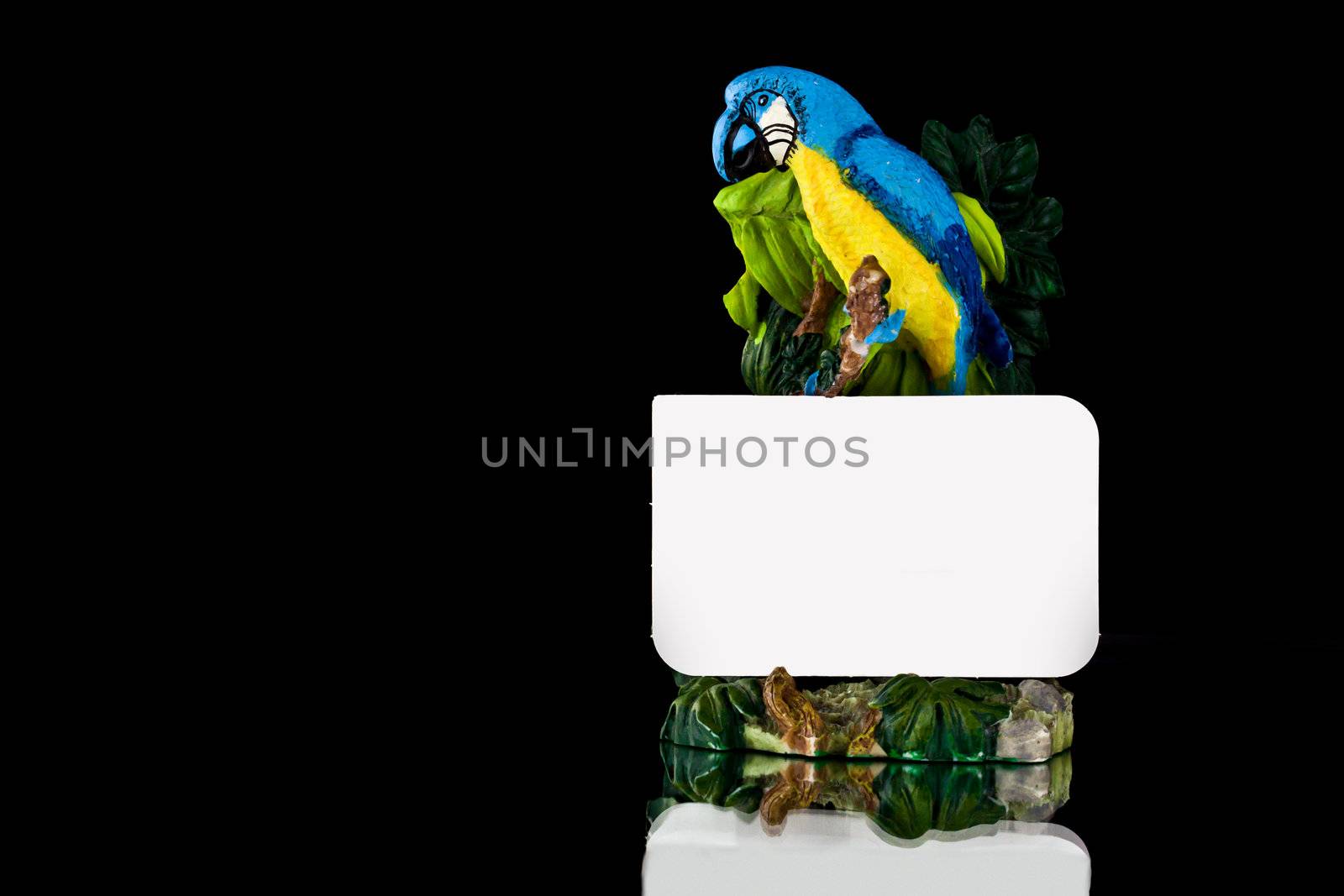 Close up picture of a parrot statue with a note 